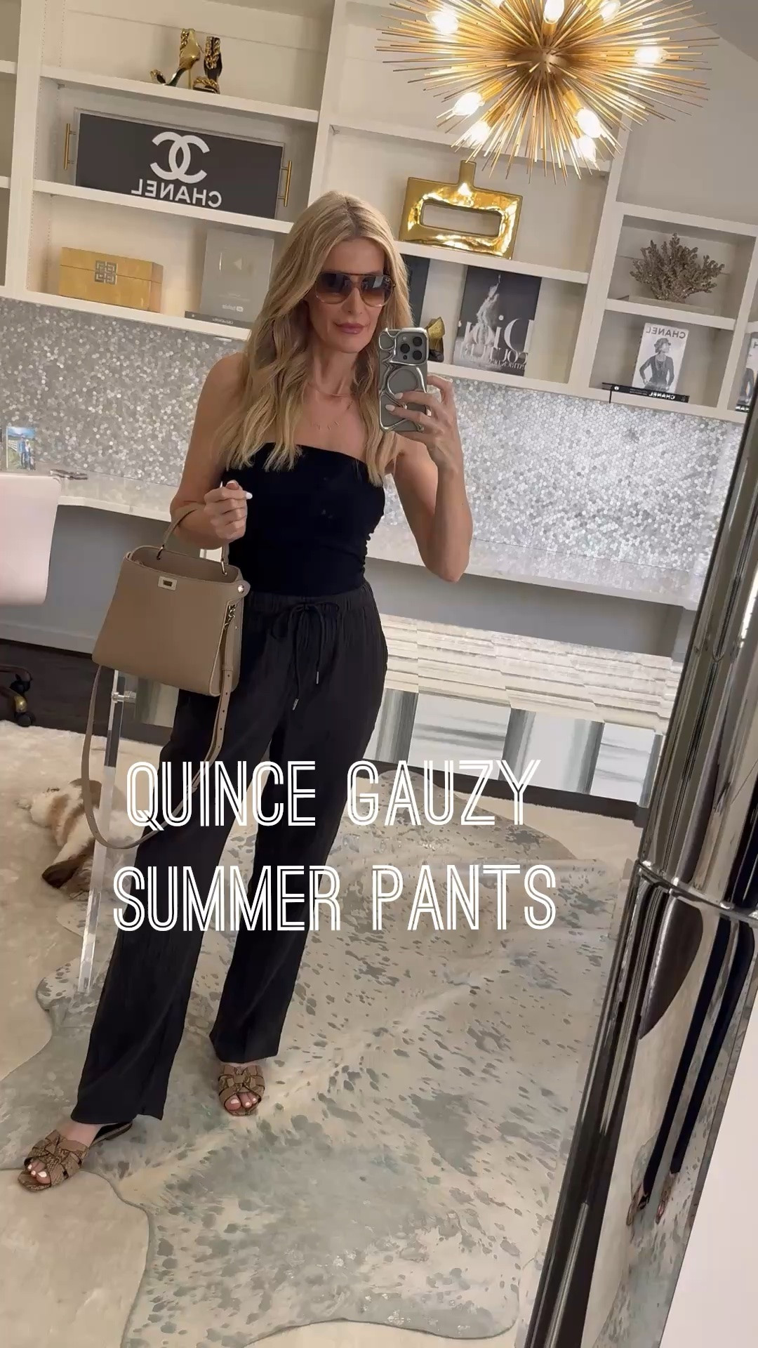 Easy casual summer outfit featuring this strapless black top, comfy wrinkle-free Quince gauze pants, and chic snake print slides. I love how the elastic waist and pockets make these pants practical, while the accessories keep the whole look elevated. I’m wearing an XS in the top and pants. #SummerOutfit #CasualChic #QuincePants #LTKOver40 

 #LTKootd #LTKSeasonal #LTKOver40