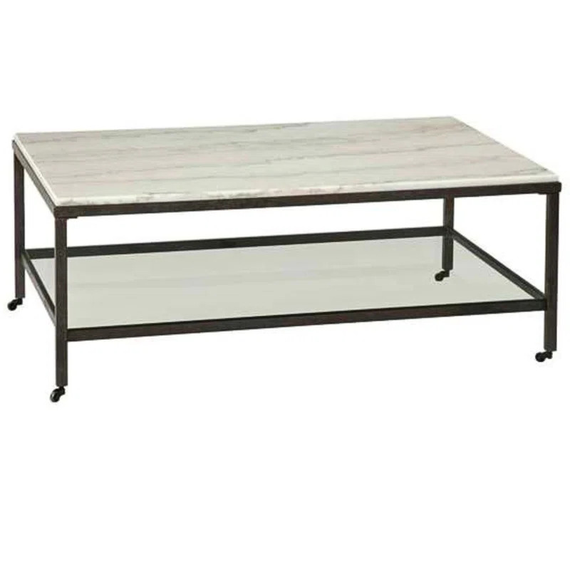 The Whitman Rectangular Cocktail Table features a striking contrast between bronze and ivory marb... | Wayfair North America