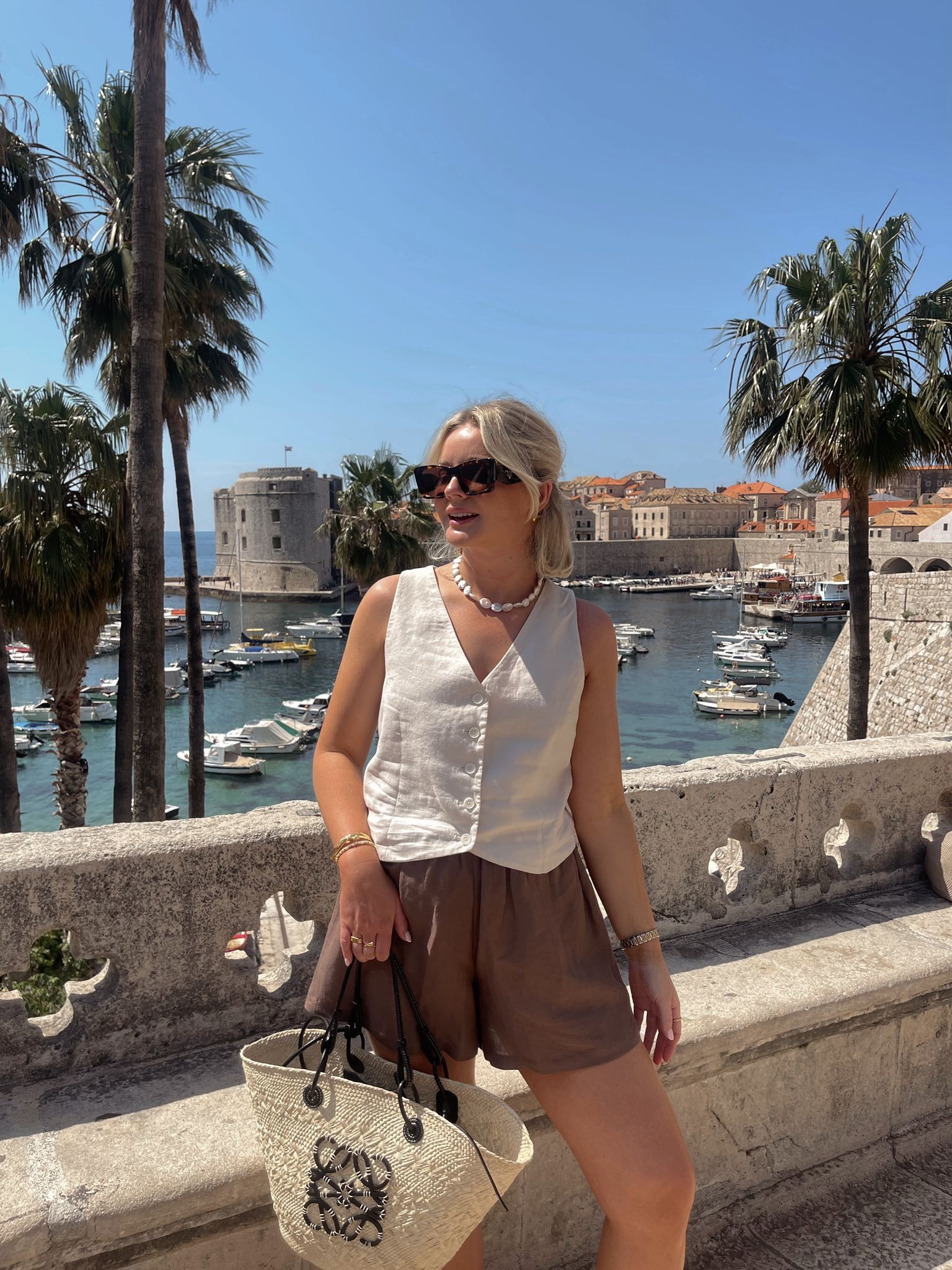 Simple but chic summer holiday outfit. Wat the brand mocha brown shorts, H&M cream waistcoat, Loewe sunglasses & basket bag, Astrid & miyu Pearl necklace

#LTKstyletip #LTKSeasonal #LTKeurope