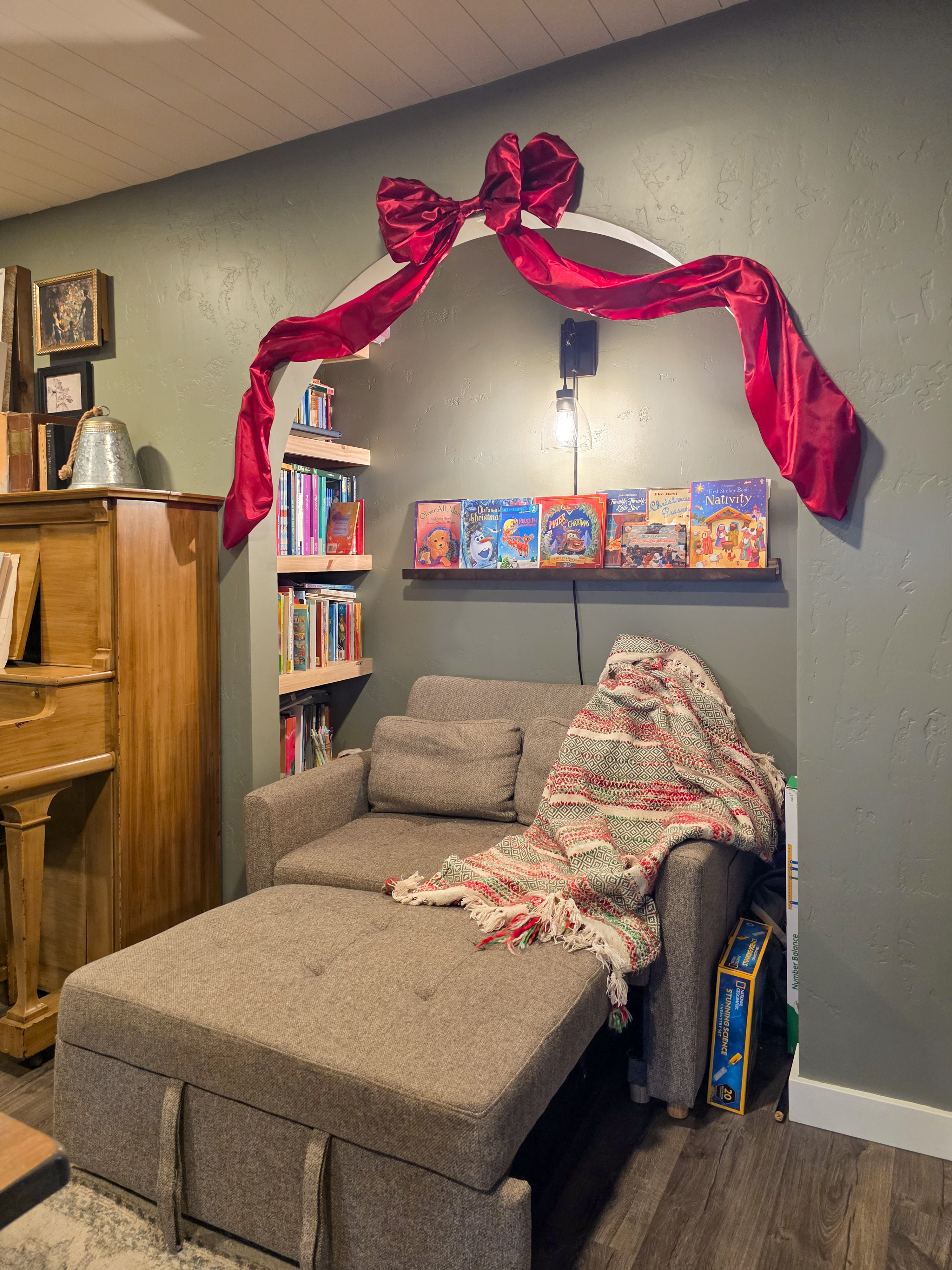 Holiday reading nook vibes: Oversized red bow over the arch and wall-to-wall books behind it. Simple, warm, and perfect for hiding with hot cocoa. 

 #LTKHoliday #LTKSeasonal #LTKHome