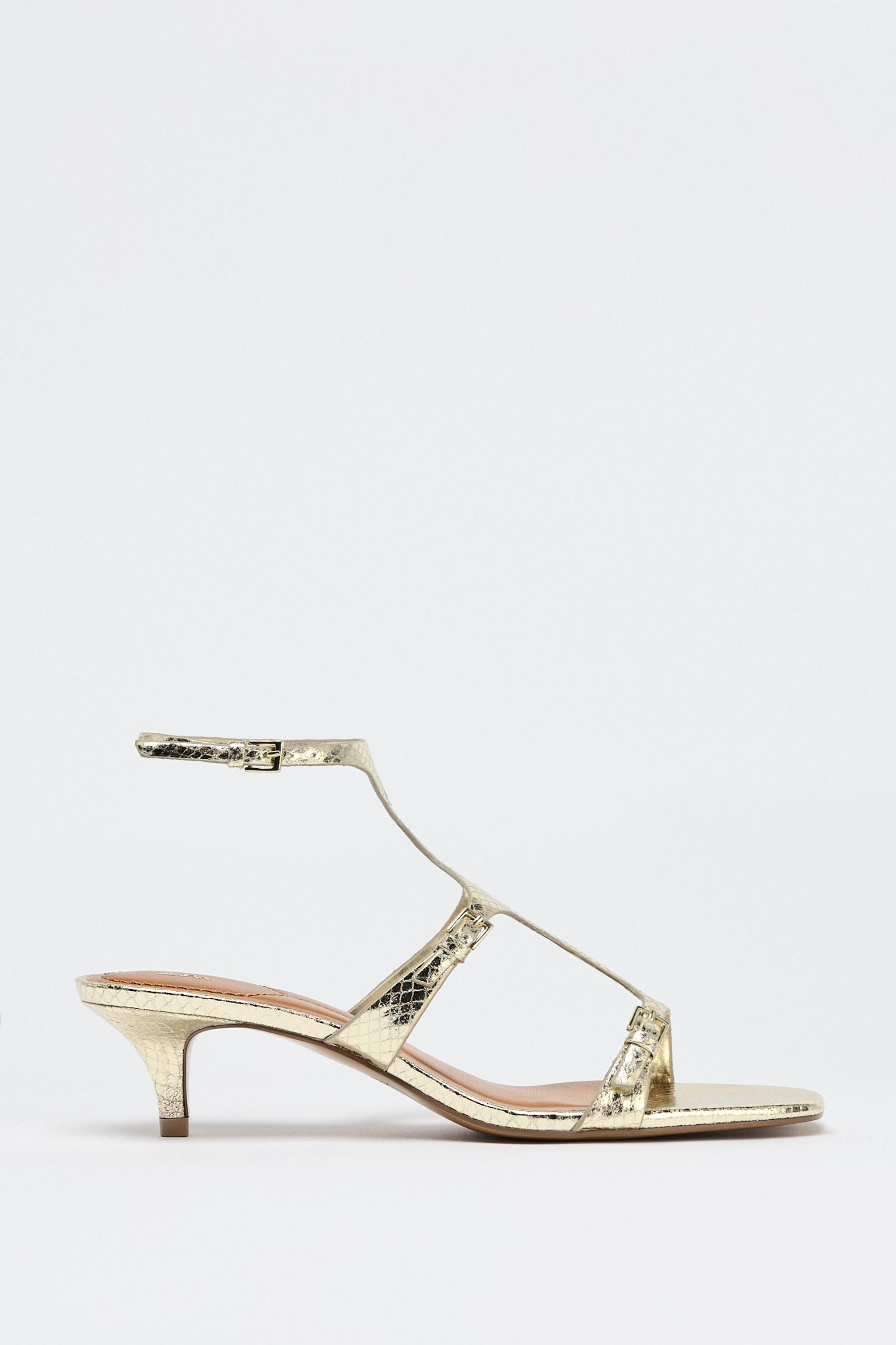 Heeled sandal shoes with metallic finish. Animal print detail. Thin straps with buckle at the fro... | Zara US