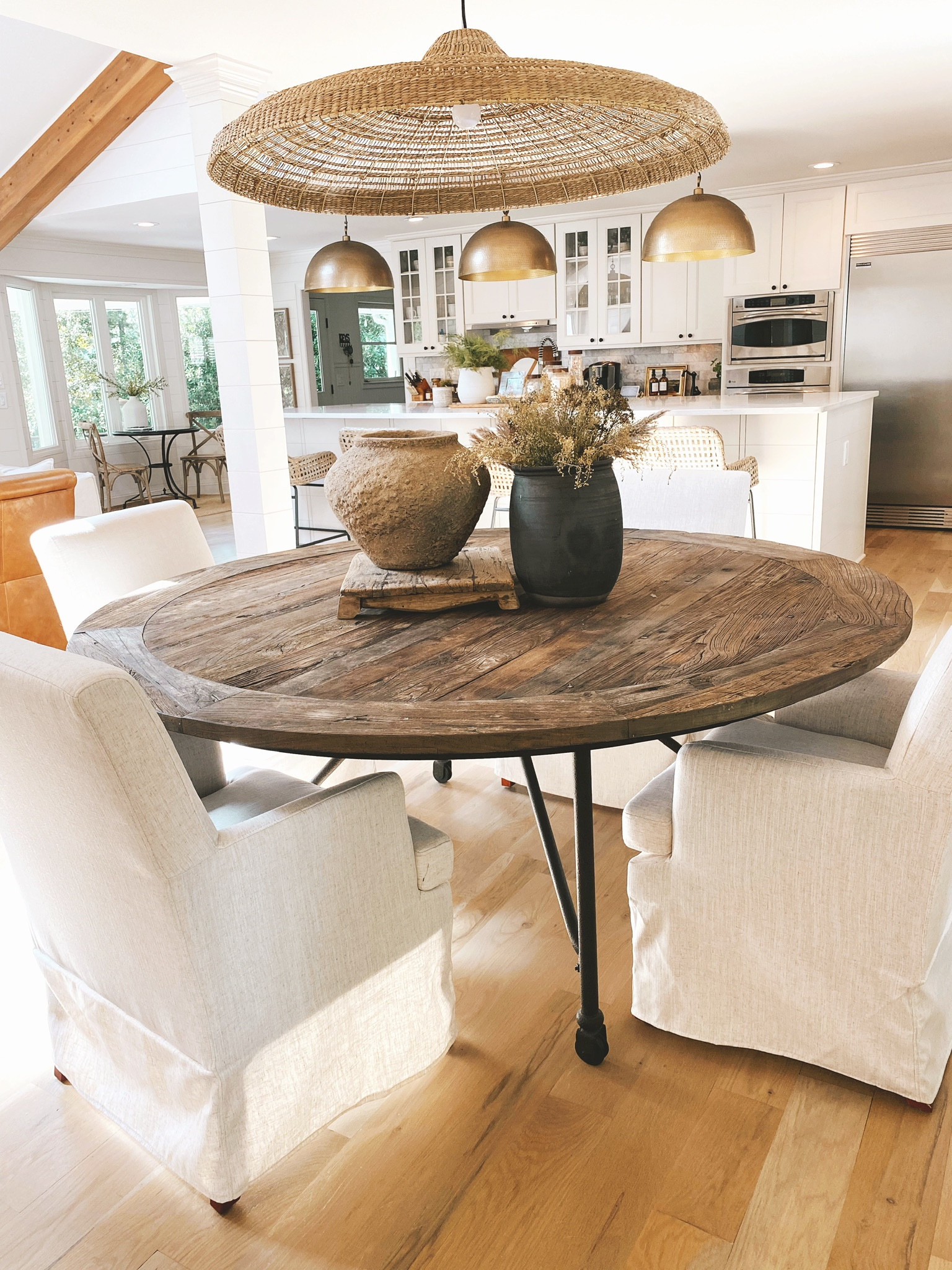 Open concept living, dining room, kitchen, round dining table, dining chairs, light fixtures #modernclassicdesign #dininginspo

#LTKSeasonal #LTKhome #LTKstyletip