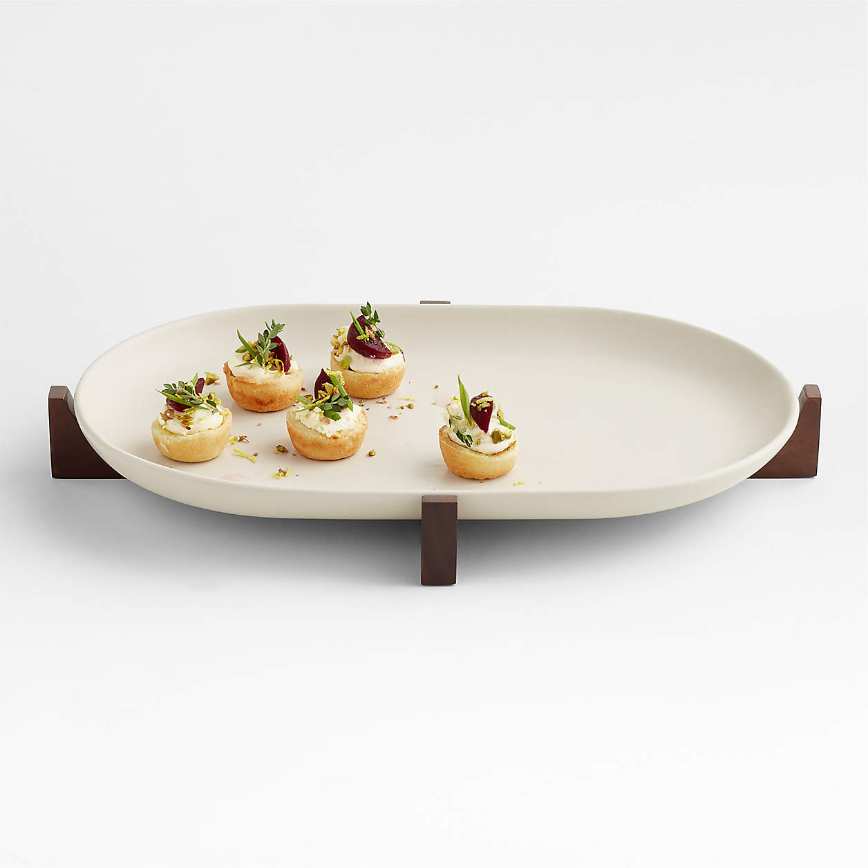 Oven-to-Table Oval Platter with Dark Wood Trivet + Reviews | Crate & Barrel | Crate & Barrel