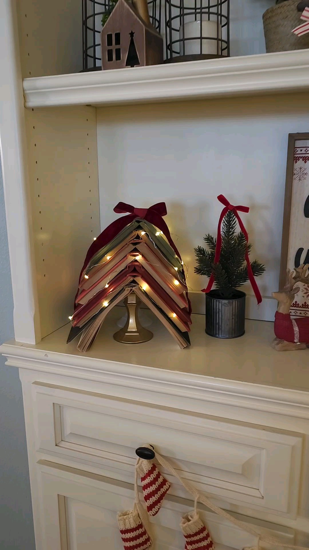 DIY vintage books Christmas tree!! Super easy. Just stack the books over each other, add some twinkling lights and a bow. It's one of my favorites and easiest diy!!Book tree / Christmas / DIY decor / bookshelves decor / shelf decor / vintage decor / vintage christmas  / cottage christmas 

#LTKHoliday #LTKSeasonal #LTKHome