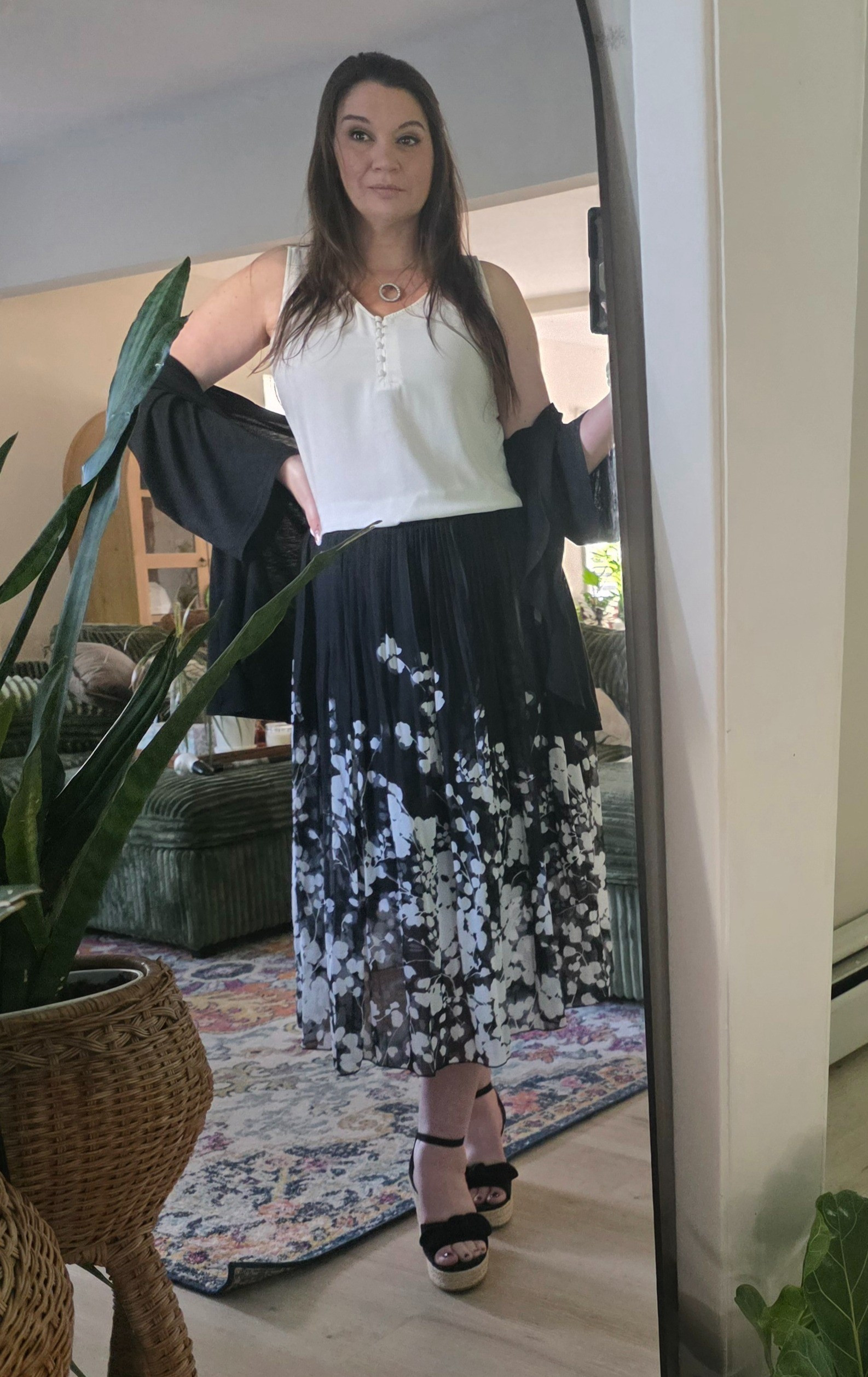 This outfit is such an easy, elegant look for spring and summer events! The flowy black-and-white floral midi skirt is lightweight and airy with beautiful movement, paired with a soft white sleeveless top that keeps the whole look fresh and effortless. I layered it with a light black wrap for just the right touch of coverage without adding heat.And can we talk about how comfortable and breathable this outfit is? For us ladies over 40, finding pieces that feel polished without feeling heavy or hot is everything — this one checks all the boxes. Feminine, flattering, comfortable, and easy to wear from daytime events to dinner out. The wedge sandals finish it off perfectly with a little height while still being easy to walk in all day.

#LTKdayinmylife #LTKOver40 #LTKWorkwear