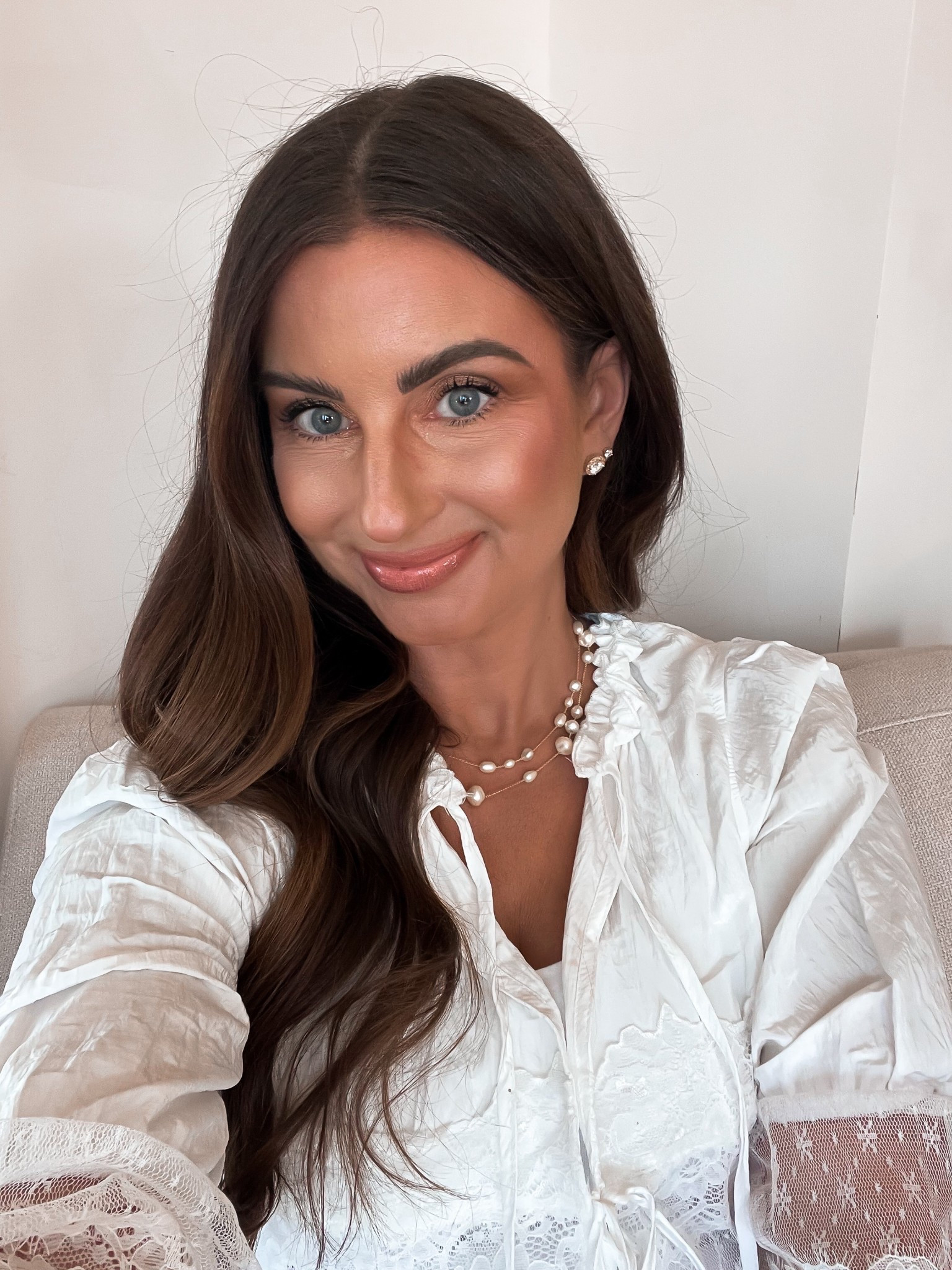 Gold pearl layered necklace 
White lace peplum top
Gold rhinestone stud earrings 