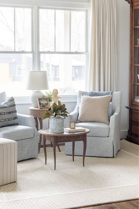 Sitting room with Loloi rug , blue chairs, magnolia stems and linen curtains 

#LTKSeasonal #LTKhome