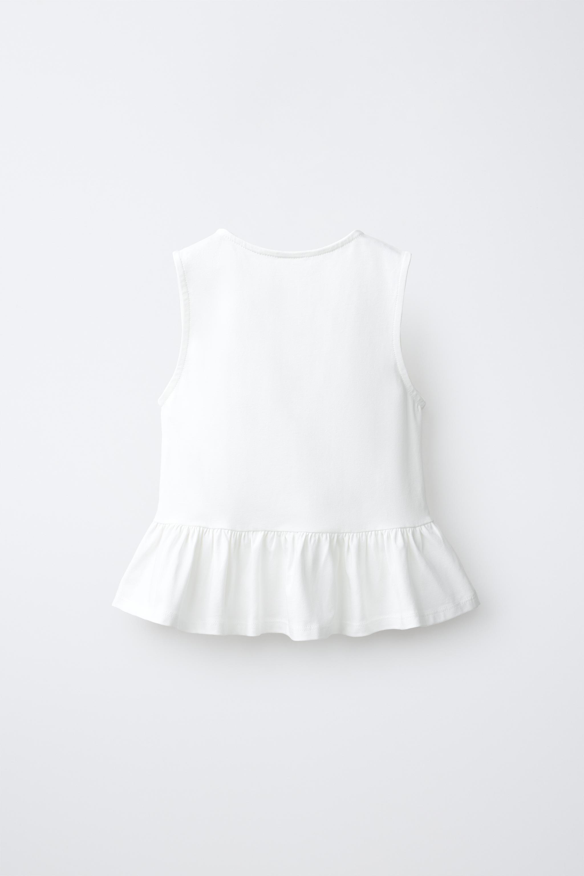 Round neck sleeveless t-shirt. Features frog fastening and button appliqu\u00e9s on the front wit... | Zara US