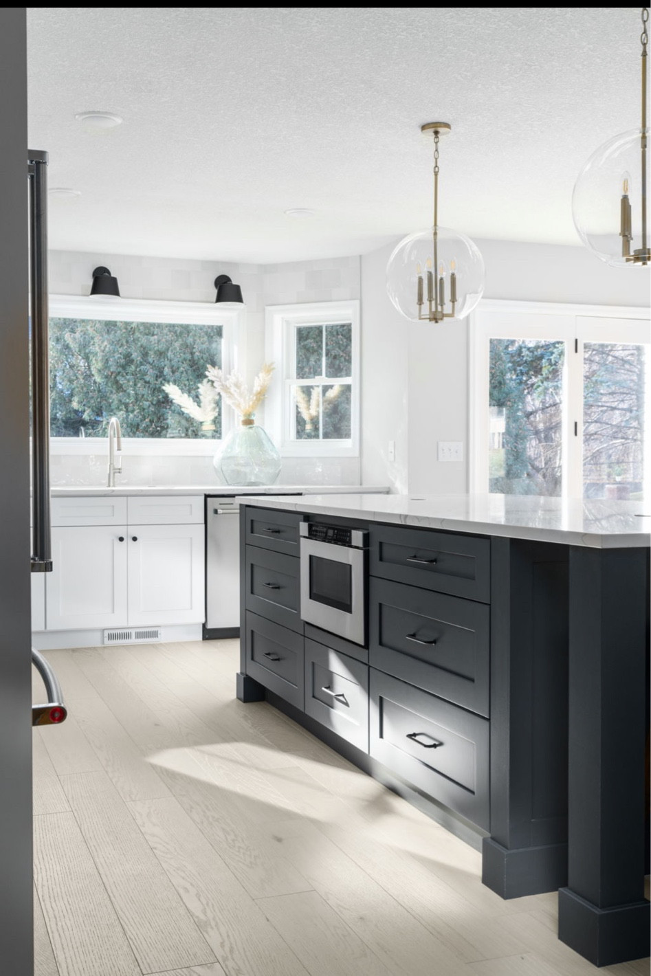 Kitchen design topped off with some stunning lighting. Contrasting the black sconces with a globe light and brushed brass is a simple way to mix metal finishes in a modern cottage style.  

#LTKCyberSaleES #LTKstyletip #LTKhome