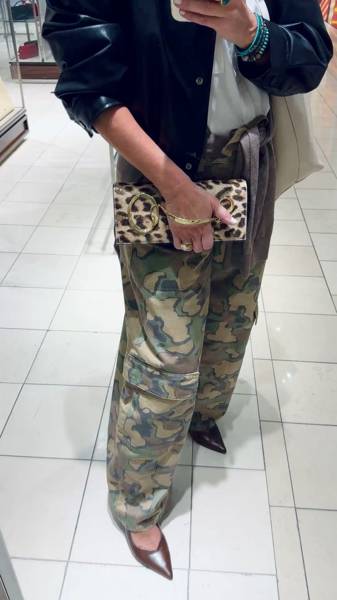 Love this Alexis Bittar clutch in leopard with unique handle