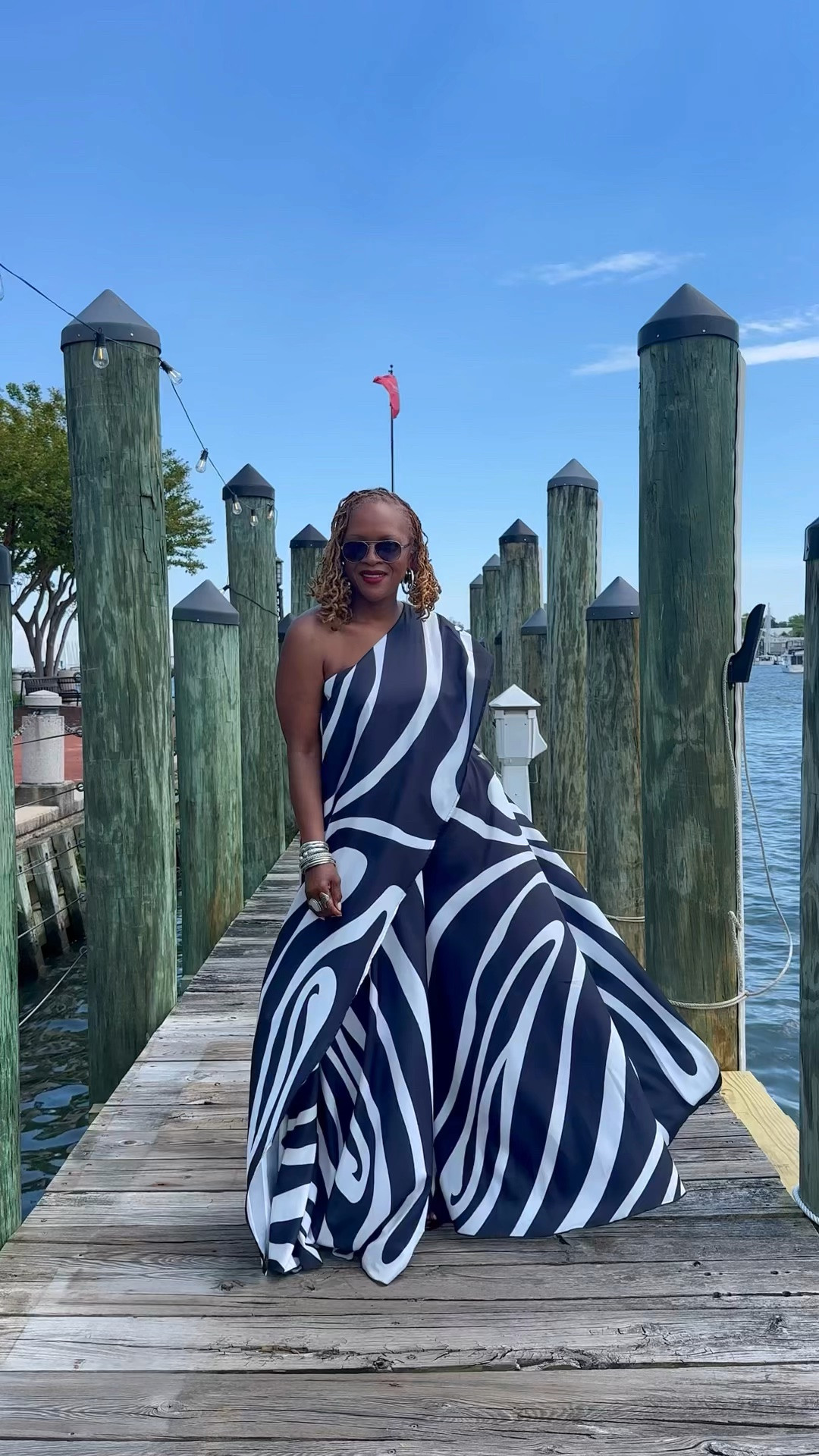Bold black and white swirl print one-shoulder draped top, perfect for fashion-forward events or vacation-ready styling. Featuring an asymmetric neckline with a dramatic oversized drape and elongated hem, this statement piece brings effortless drama with a sleek, modern edge. The fluid, lightweight fabric creates beautiful movement while the graphic print guarantees all eyes on you, finished with an inner mesh cami for secure wear. Pair with the matching AKIRA Label Trina Pleated Palazzo Pant for an ultra-chic, matching moment.

#LTKootd #LTKdayinmylife #LTKvlog