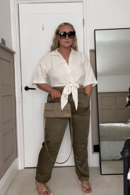 A crinkled cropped blouse light and sheer,paired with silk olive trousers cream heels and a khaki jaq bag. 

#LTKcurves #LTKstyletip #LTKfit