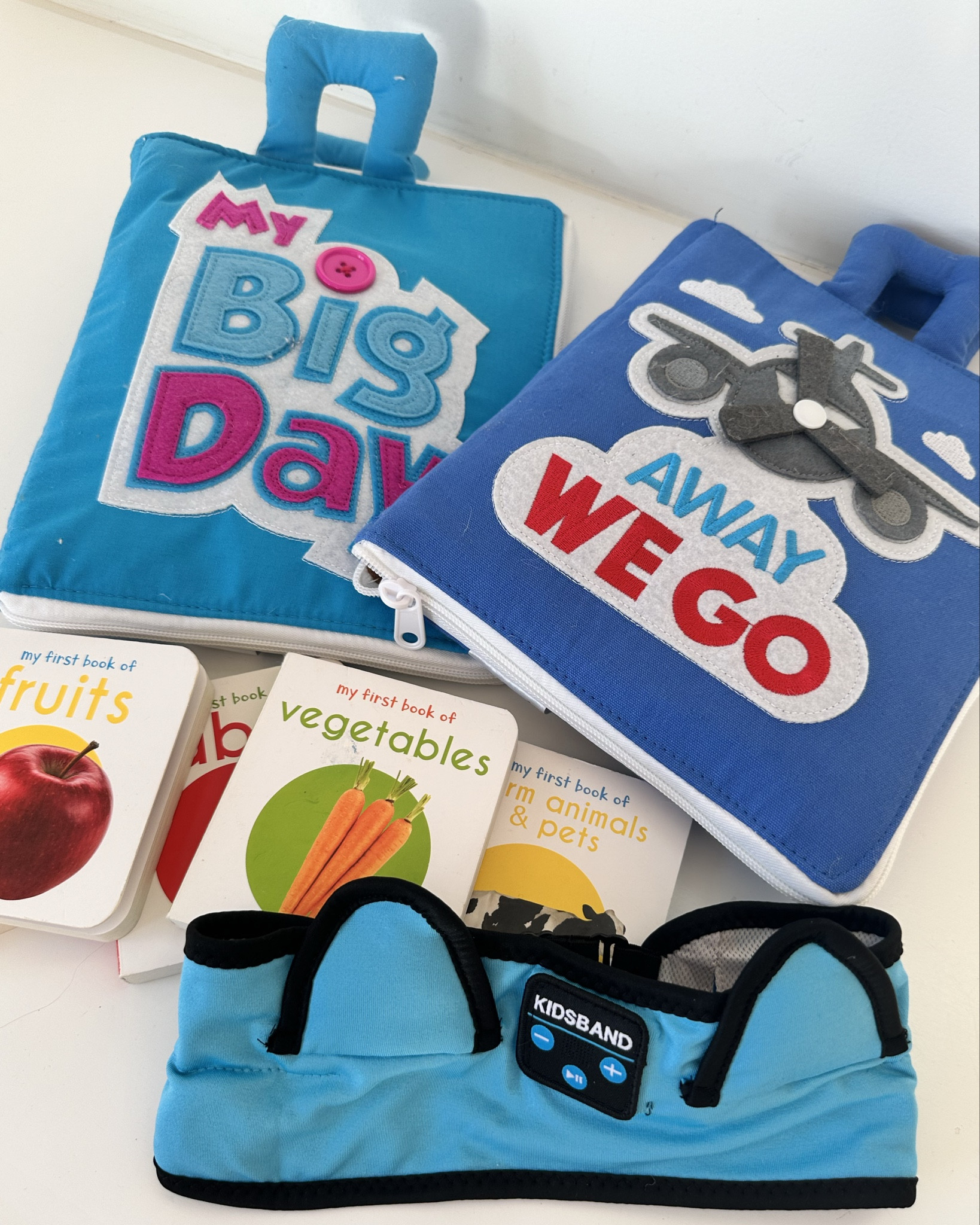 My toddler airplane survival kit. These busy books are perfect for my 19-month-old. They include lots of Velcro activities to keep a toddler entertained. 
My son also loves this set of tiny picture board books. I packed his diaper bag full of these books because he loves flipping through them with me. 
If you allow screen time (it’s a much needed break for me on a flight), these Bluetooth headphones are great for a toddler. 
Also, snacks are a must for a toddler to keep them happy on long trips. These snack containers easily fit in the diaper bag, and my son loved being able eat a variety of snacks on the plane. 

#LTKkids #LTKtravel #LTKbaby