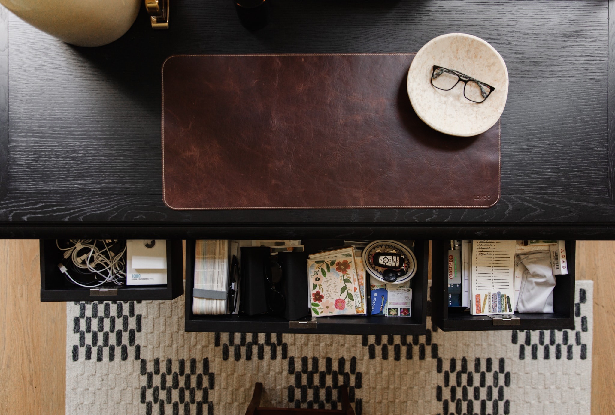 Curious what we keep in our kitchen desk? Take a peek inside at ChrisLovesJulia.com 🖤

Black traditional desk, leather desk mat, marble bowl, Bradley loloi rug

#LTKhome #LTKfamily