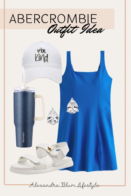 Stunning dark blue mini active dress from Abercrombie! I paired this with strap white sandals, tear drop diamond earrings, dark blue tumbler, and a white baseball cap! Amazon accessories! Travel outfit! Summer outfit! Spring outfit! 

#LTKshoecrush #LTKActive #LTKfindsunder100