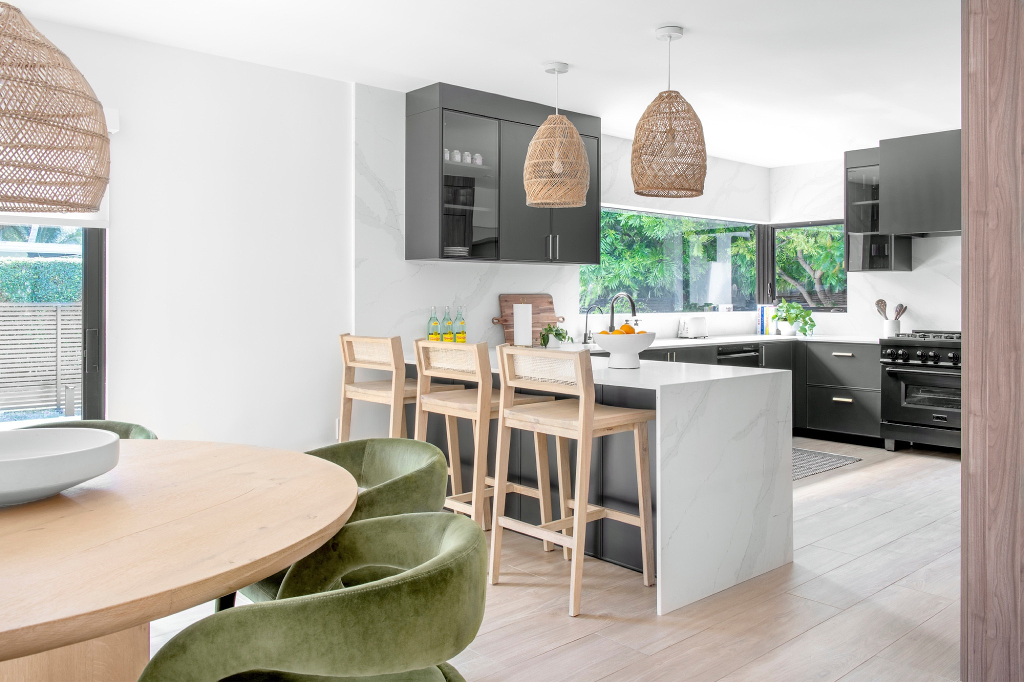 This partial gut renovation was tailored for a dynamic family of four. Each space was meticulously crafted to reflect the eclectic taste of its owners. Explore the unique features that define this home's vibrant personality.

The kitchen seamlessly marries aesthetics with functionality with bold, contemporary black kitchen cabinets. We incorporated cane counter stools and rattan light fixtures for a boho vibe. 

#LTKhome #LTKMostLoved #LTKfamily