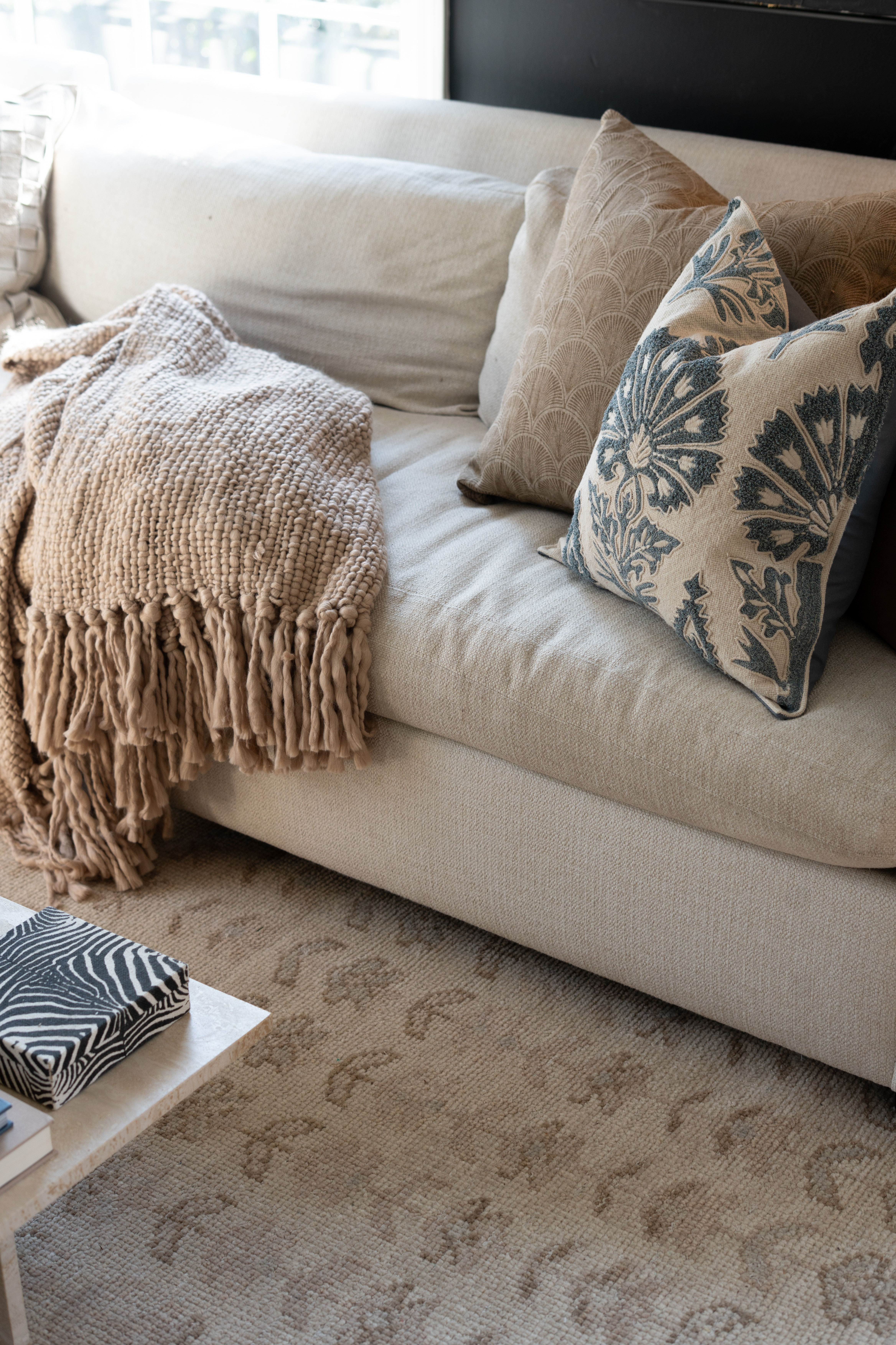 Ahhhh I swear a cozy throw blanket and beautiful pillows can completely transform a space. The neutral sofa, warm textures, and subtle blue accent pillow make this living room feel so calm, cozy, and effortlessly styled. Obsessed is an understatement!  

 #LTKSpringSale #LTKSeasonal #LTKHome