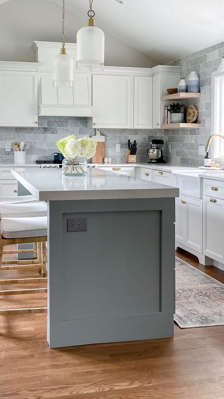 Bright white coastal style kitchen with white cabinets, brass fixtures, Serena and Lily barstools

#LTKfamily #LTKhome