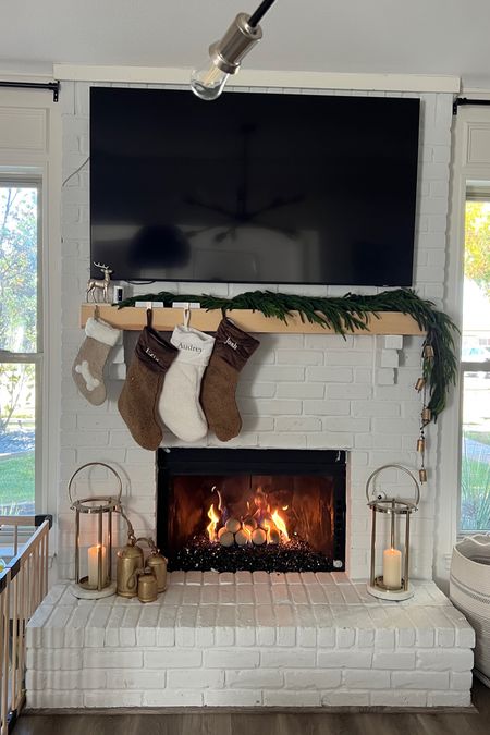 Christmas mantle 🎄 Our pottery barn stockings, I used 2 garlands (these are gorgeous), antique bells, and candle lanterns

#LTKHoliday #LTKSeasonal #LTKhome