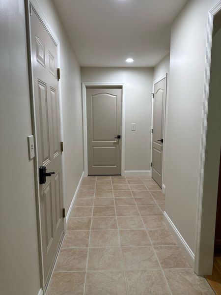 Garage door hallway entryway refresh! 

Wooden outlet covers I painted, new door handles, grout magic! 

Wall color: SW white sesame 
Trim color: SW west-highland white 
Door color: SW balanced beige 
Grout color: bisque 

Also added new lighting ! Different lightbulbs 