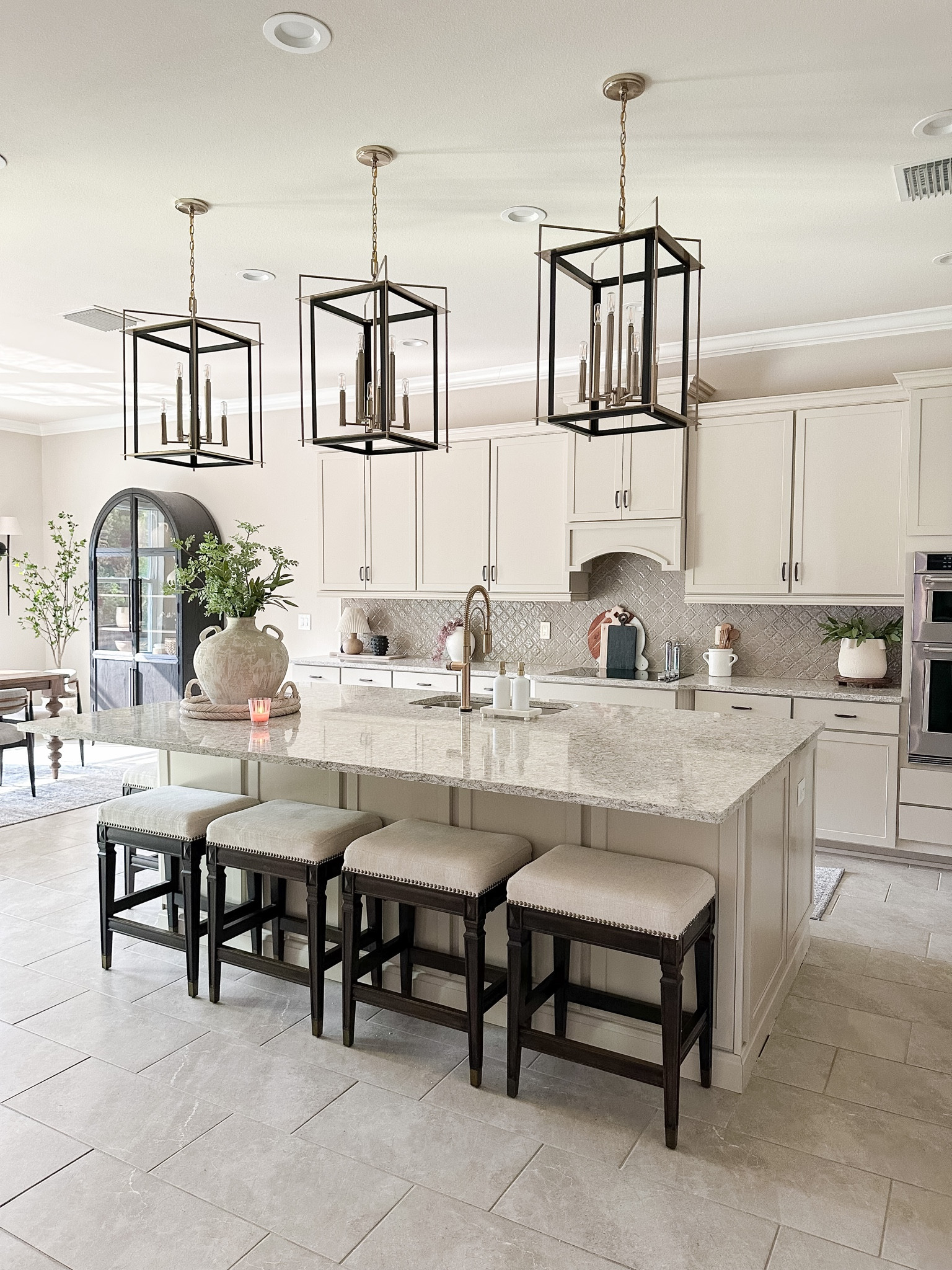 Updated kitchen view! Loving our new faucet upgrade. Similar options linked! 

Kitchen faucet, barstools, kitchen pendant lights, arch cabinet 

#LTKhome