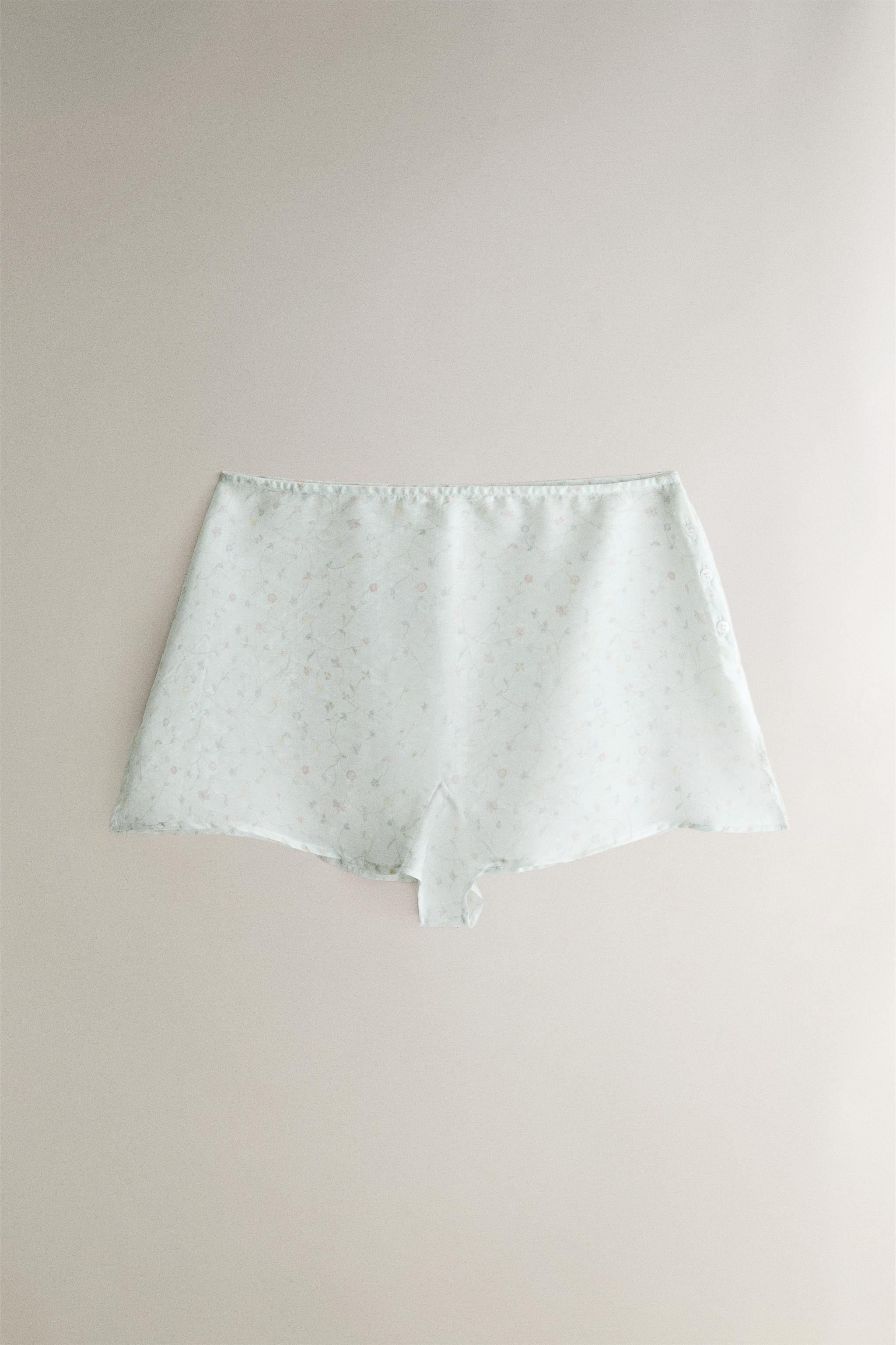 Sheer shorts featuring a colorful floral print with branch motifs and small side slits. | Zara US