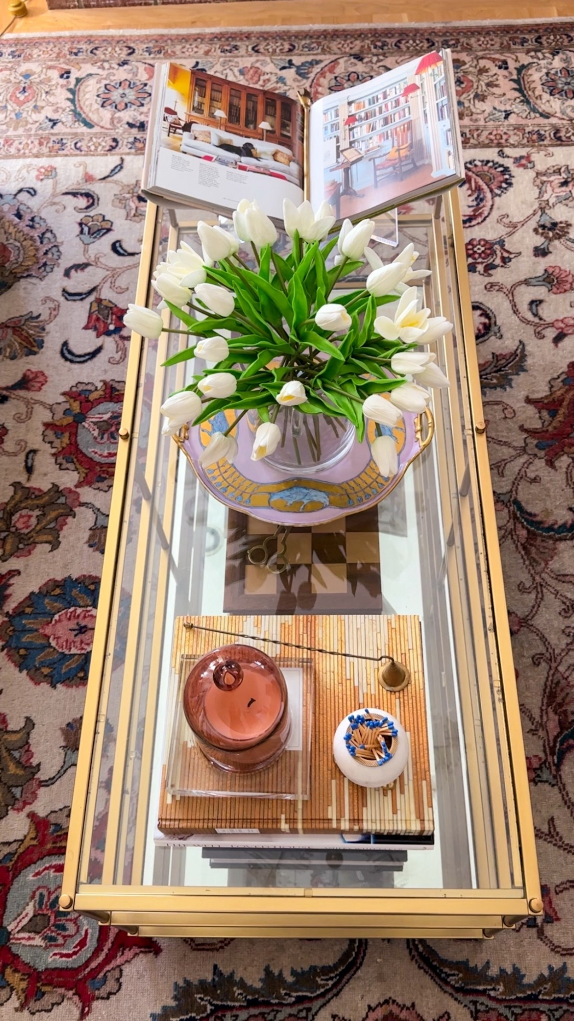 Spring coffee table styling with pinks, pastels, tulips and layered coffee table design books. #coffeetablestyling #interiordesign #springdecor #springflorals 

#LTKHome