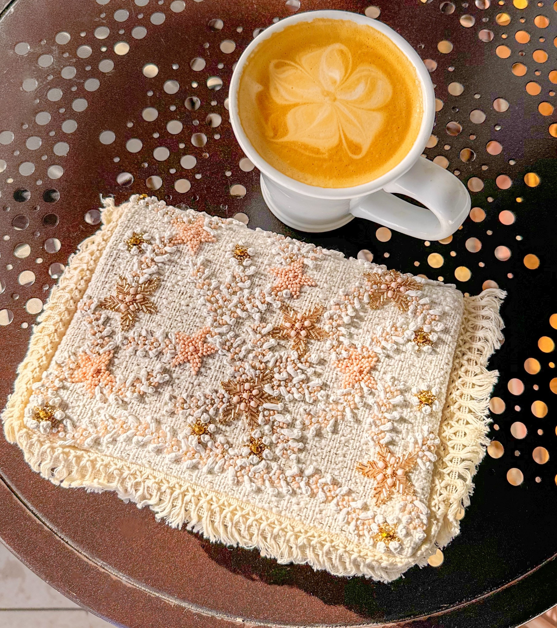 🌟Add a touch of beach vibes to your wardrobe with this stunning embroidered clutch bag! 🌟 This beautiful accessory features intricate designs with delicate beadwork. The cream-colored fabric is adorned with star-shaped patterns in soft peach and gold tones, accented with white and gold beads. The edges are finished with a lovely crochet trim, making it perfect for special occasions or adding a unique flair to any outfit. 
🌊☀️

Includes attachable gold chain. 

#LTKItBag #LTKSpringSale #LTKTravel