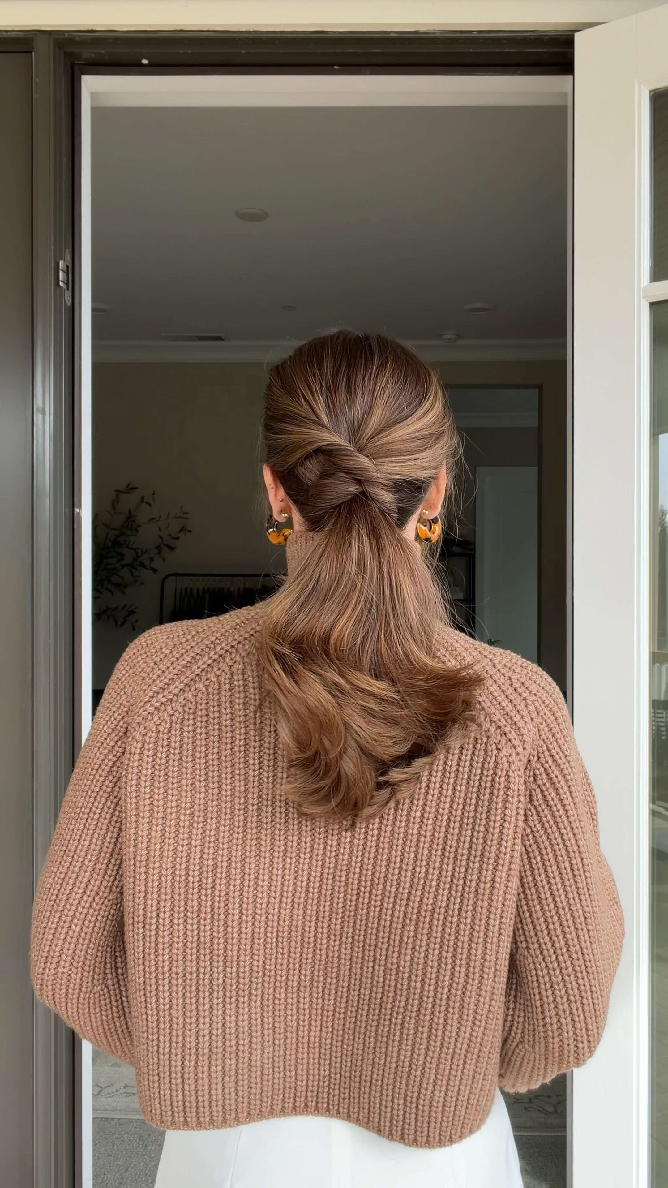 The ponytail hack you need to try ✨

Leave out a small section of hair on each side of your head. Bring both sections to the back and secure them together with a clear elastic. Flip the ponytail through the opening toward your scalp twice to create a soft twist. Insert your thumb and index finger through the opening from underneath, twist upward, and pull the remaining hair through.

Simple, secure, and chic with no elastics in sight 💁‍♀️ 

 #LTKgrwm #LTKootd #LTKBeauty