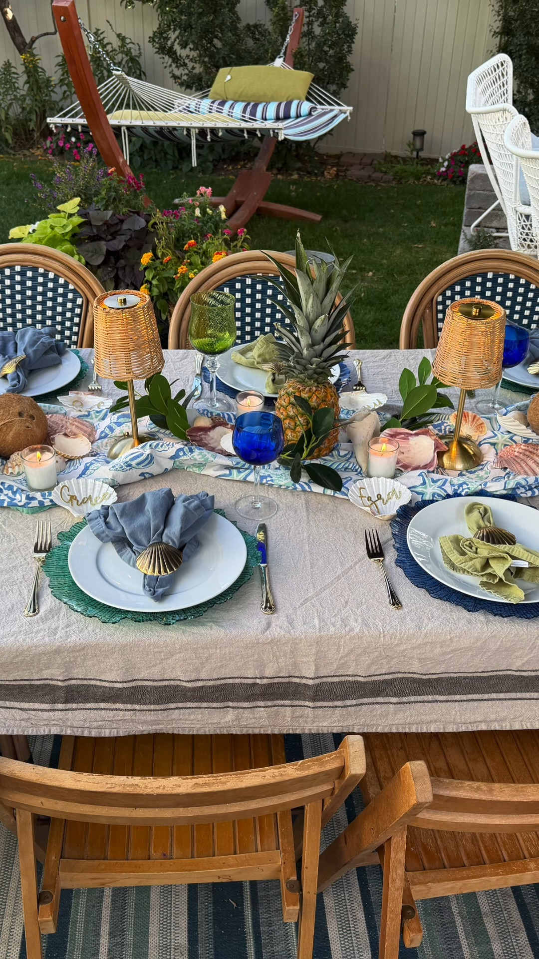 A fun Hawaiian backyard homecoming dinner in blue and green!  Blue and green goblets, blue and green cloth napkins, mini wicker lamps and blue and green chargers. Place a neutral tablecloth and top with a sea shell tablecloth scrunched as a runner. #tablescape #beachytable

#LTKHome