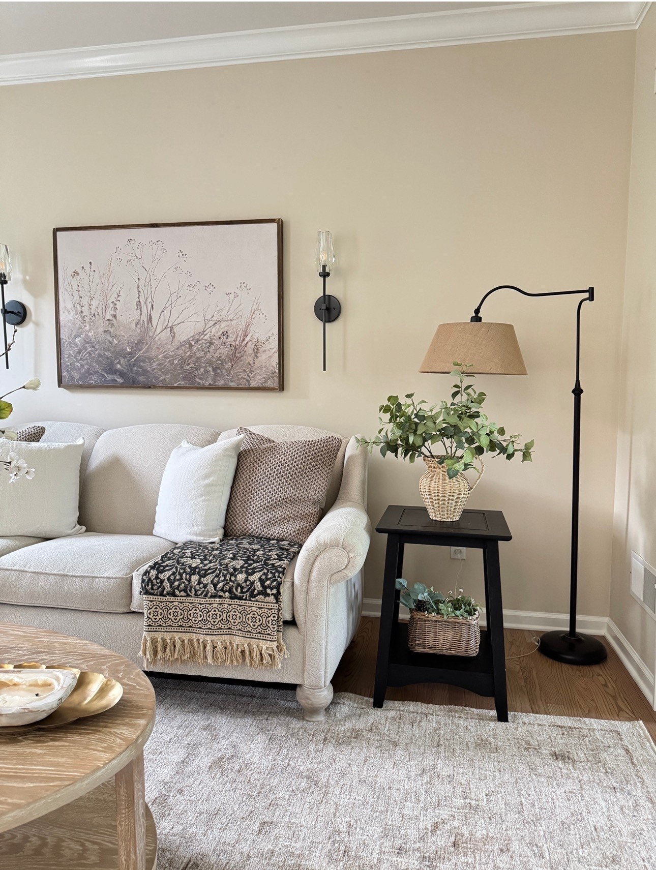 My solid wood end tables come unfinished so you can stain or paint them any color you like - at a great price! Also sharing my floor lamp but in brushed gold, solid wood framed wall art, crystal wall sconces, block print floral throw, solid wood oval coffee table, light neutral wicker pitcher vase, similar stems, scalloped brass tray, throw pillow covers  