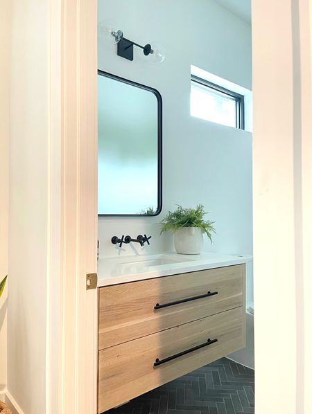 Bathroom decor. Cabinet hardware. Vanity lights. Black metal frame mirror.  Black herringbone tile.  White Organic bath towels. Modern bathroom.  Bathroom tile.  Studio Mcgee Art print.  #targetstyle

#LTKunder50 #LTKsalealert #LTKhome