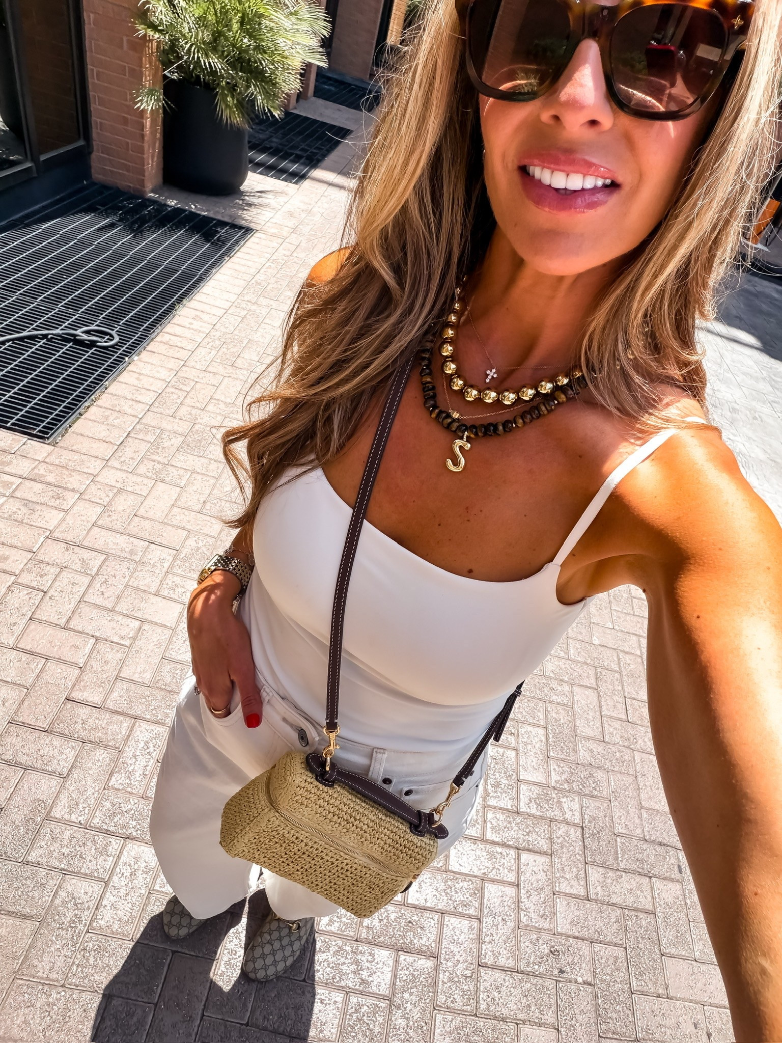 This white tank and denim combo is one of my favorite summer outfit formulas. I dressed it up with layered statement necklaces, a woven crossbody, and neutral accessories for an easy look that works from lunch to running errands.

white tank, white jeans, summer outfit, layered necklaces, woven crossbody bag, casual chic outfit, everyday style, neutral accessories, effortless summer look, vacation outfit, elevated basics, themominstyle

#LTKOver40 #LTKootd #LTKSeasonal