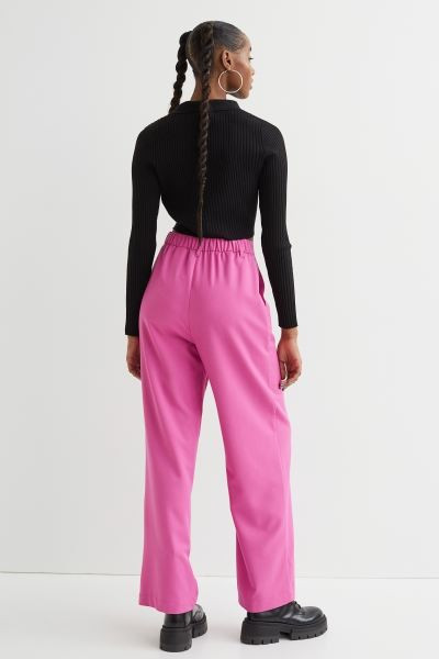 Conscious choice  Wide-cut pants in woven, slightly stretchy fabric with a high waist. Covered el... | H&M (US + CA)