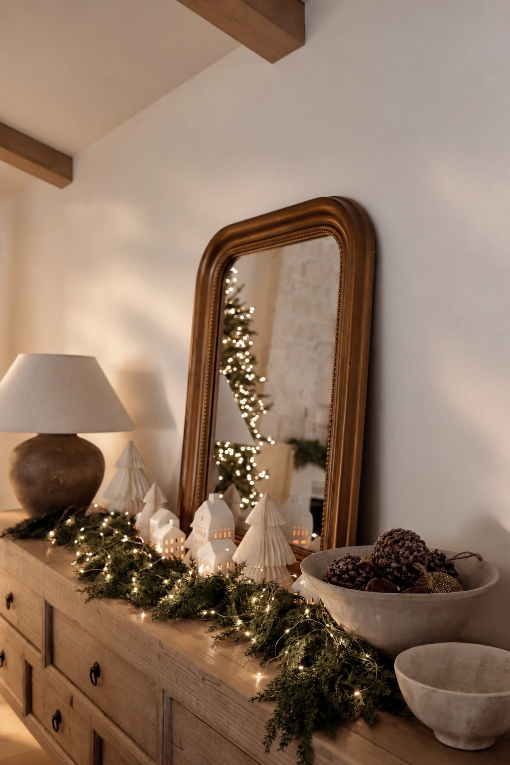 A little Christmas village magic! ✨🎄 Layered garland, ceramic houses, mini trees, and twinkle lights to create the coziest holiday display. Linking everything I used to recreate the look! 🤎

#ChristmasDecor #ChristmasVillage #HolidayStyling #ChristmasHomeDecor