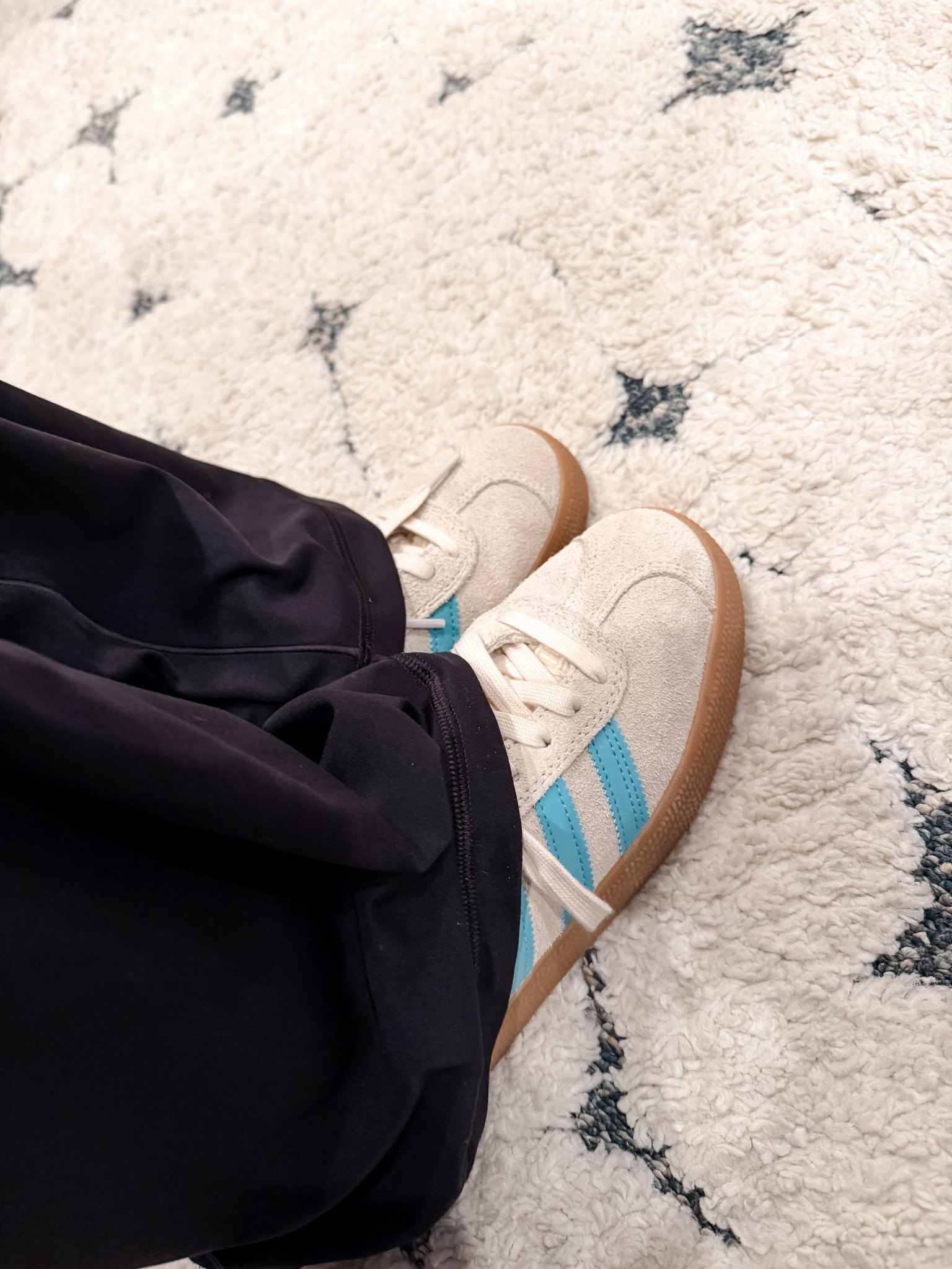 The best go to sneakers for soccer moms and active moms on their feet, Adidas handball with blue stripes