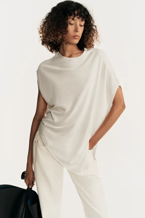 Flowy round neck top. Asymmetric sleeves and hem. | Zara US
