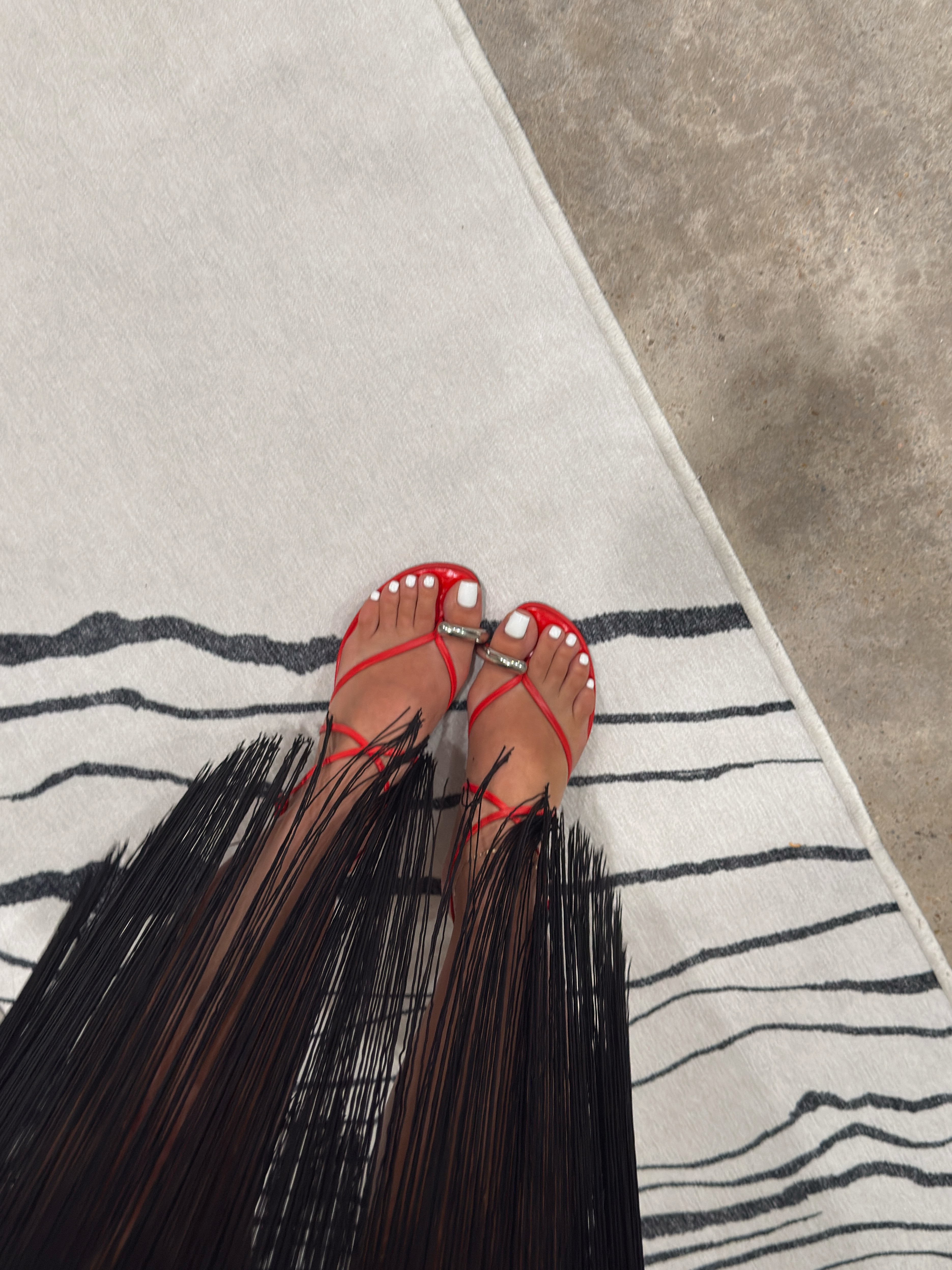 Red hot and ready 🔥 these Tory Burch strappy sandals are the perfect pop of color against a black fringe skirt — that little red buckle detail is doing SO much. Sizing up on shoes and skirt combos like this one for the rest of summer. These red are practically sold out so linking another color. #shoes #ltkshoes #heels #toryburch 

 