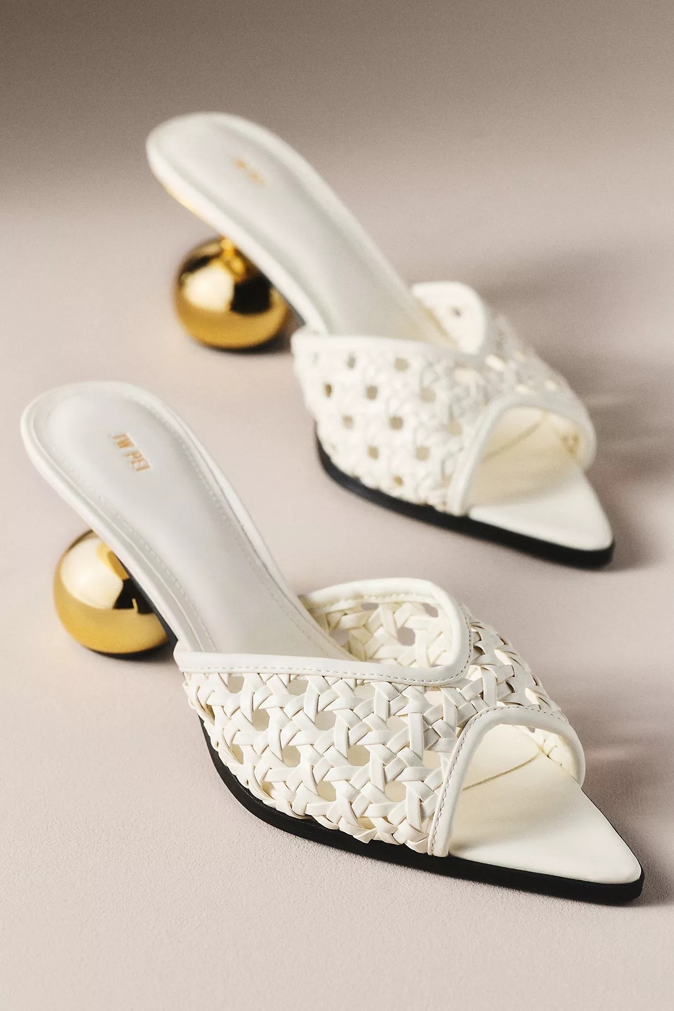 ✨ Chic meets statement style! These white woven slide sandals feature an eye-catching gold sphere heel that instantly elevates any outfit. The pointed square toe and intricate basket-weave design give them a luxe designer-inspired look, while the slip-on style makes them easy to wear from brunch to date night. Pair them with linen dresses, denim, or tailored trousers for an effortlessly sophisticated summer look.

#LTKWedding #LTKTravel #LTKSeasonal