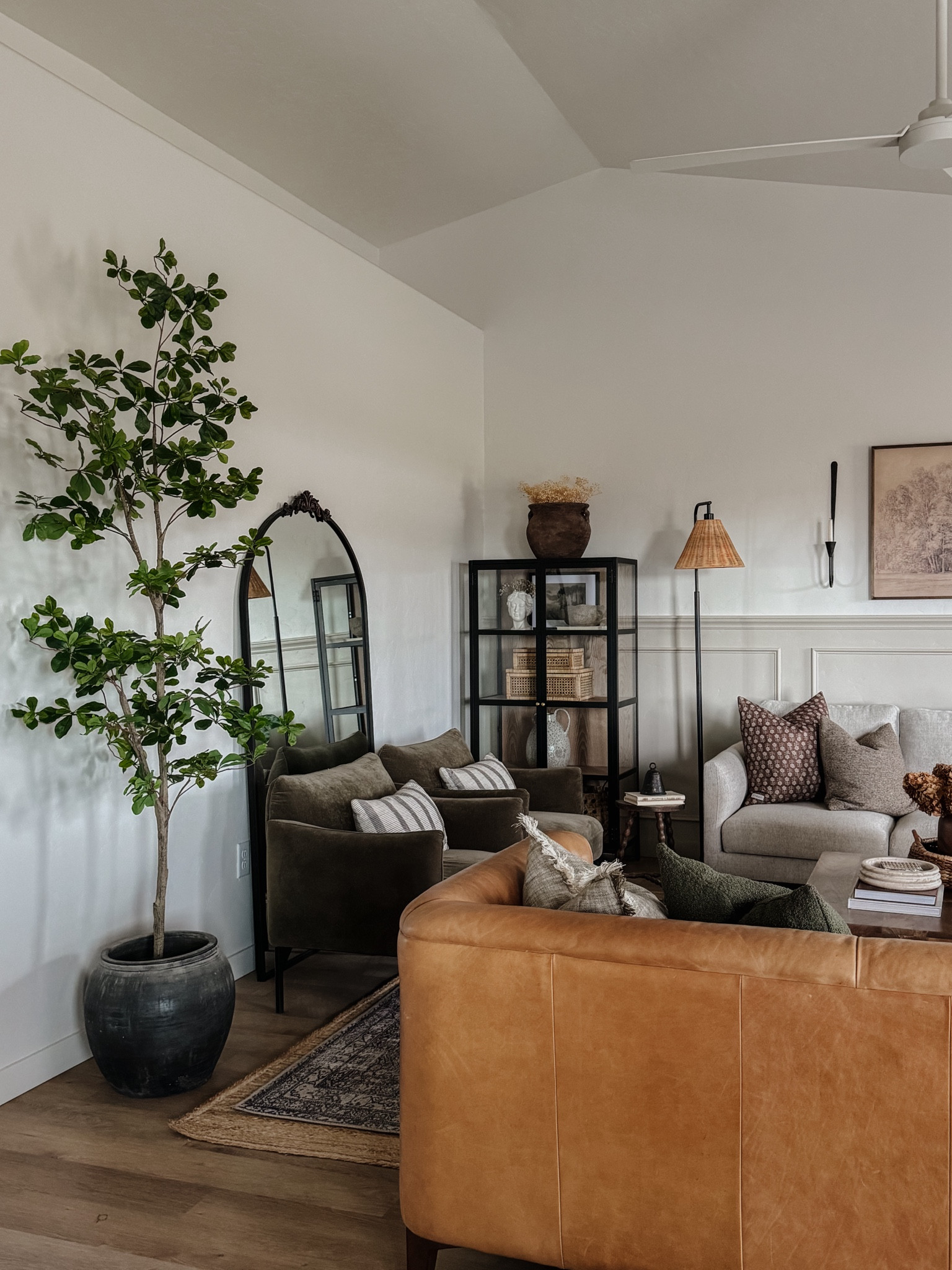 Faux black olive tree, shady lady tree, Amazon find, faux tree, budget friendly, Living room inspo, pinch pleat curtains, floor to ceiling curtains, neutral sofa, beige sofa, west elm penn chair, green accent chair, vintage pillows, Turkish pillows, shady lady tree, faux tree, greenery, Walmart floor lamp, woven table tray, square wooden coffee table, wall sconce, tapered candle holder, throw pillows, floor length mirror, arch mirror, Target home decor, affordable home, black cabinet, studio McGee cabinet, table,ltarget accent table, vintage inspired rug, vintage milking stool, foot stool


#LTKstyletip #LTKhome #LTKsalealert