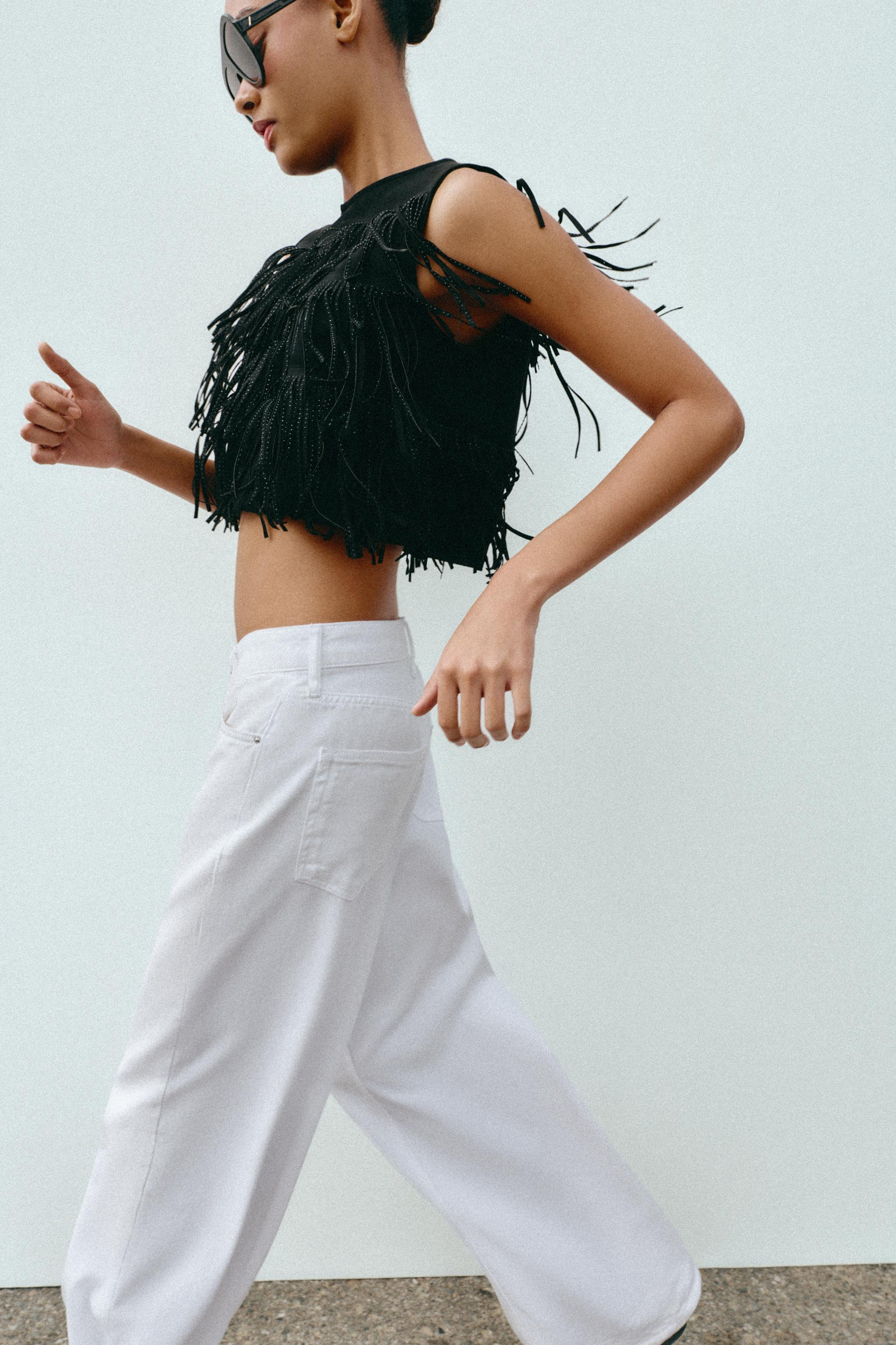 Short round neck sleeveless top. Featuring fringed appliqués with studs. Invisible zip fastening... | Zara UK