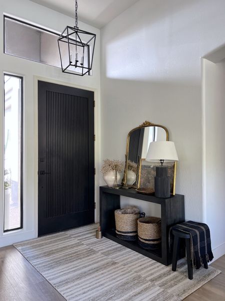 Entryway styling 
Console table 
Entryway table 
Baskets
Black lamp
Anthropologie accent mirror 
Vase 
Dried botanical 
Wooden tray 
Pottery Barn Candle
Area Rug 
pendant light 
Wooden stool
Black throw blanket 
Door stopper 

#LTKhome #LTKunder50 #LTKunder100