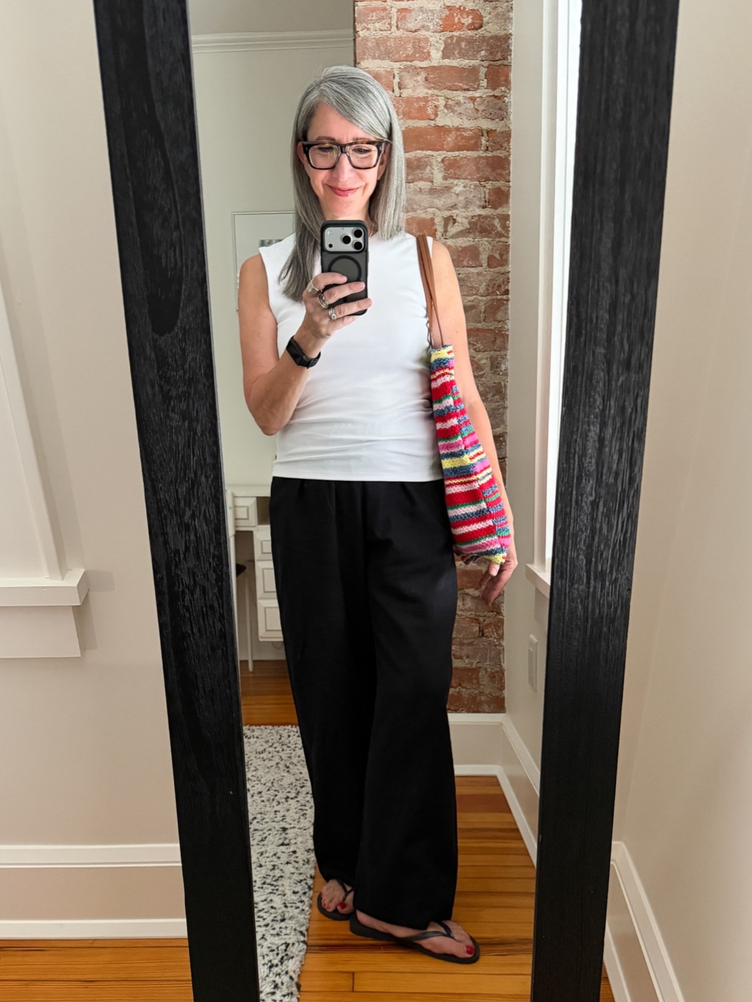 Zara white crewneck tank, black linen wide leg pants, jelly flip flops, Gap crochet tote - simple summer neutrals. Three weeks, one tank, last stop — white this time with black linen pants and flip flops. The simplest formula there is, elevated by two quiet upgrades: a more structured tank instead of a basic cotton tee, and linen instead of plain cotton on the pants. The crochet bag does the rest.
Everything linkable is linked here! @Zara

#LTKootd #LTKgrwm #LTKOver40