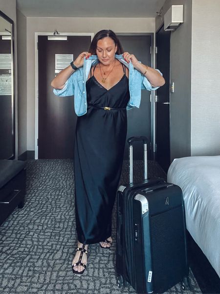 Travel style. Carry on case. Travel pro. Suitcase. Silk dress. Satin dress. Long black dress. Denim shirt. Cropped shirt. 

#LTKover40 #LTKstyletip #LTKtravel