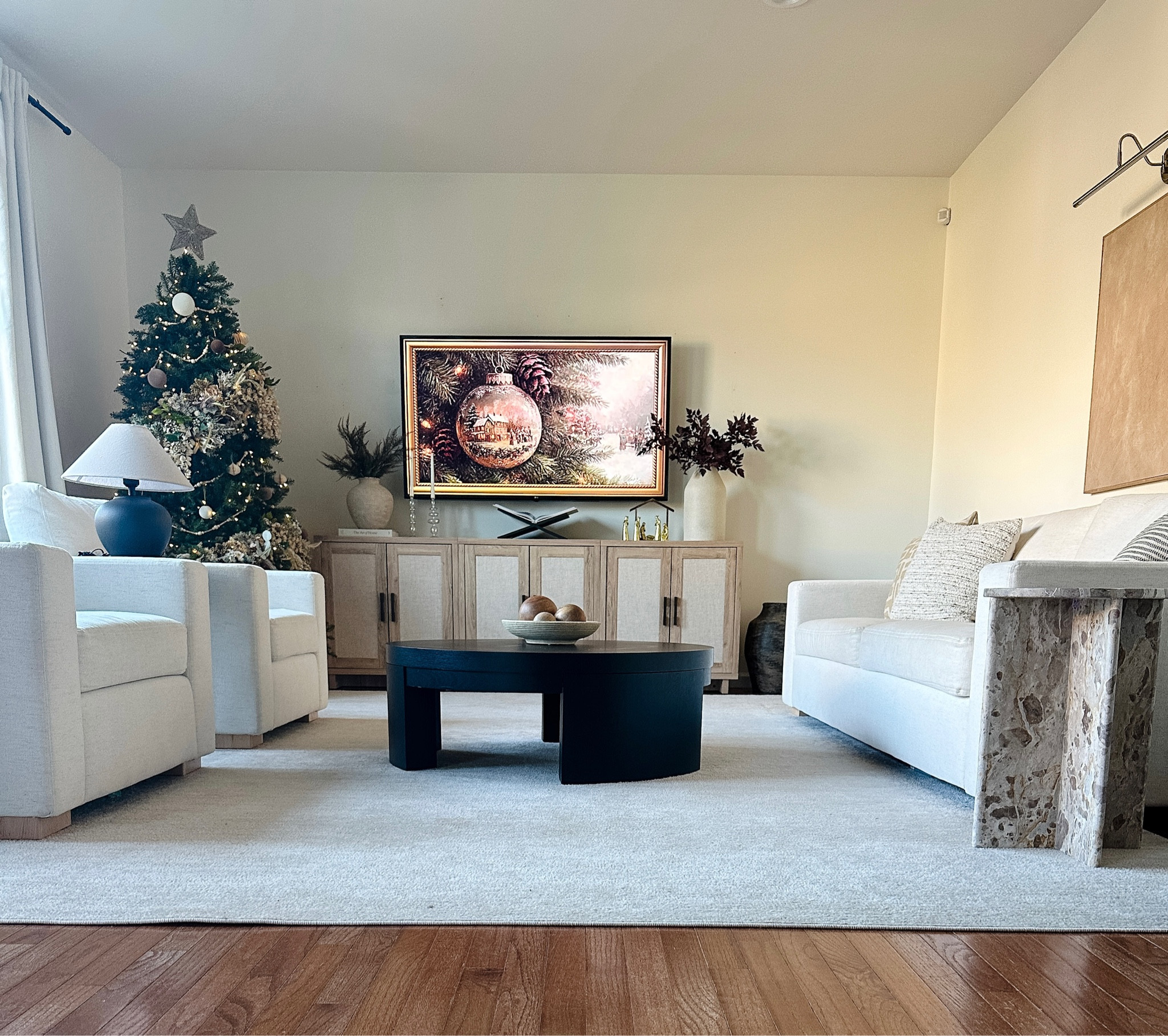 Christmas Living room, white furniture, beige rug, black round coffee table, white couch, accent chairs, TV stand

#LTKHoliday #LTKHome #LTKSeasonal
