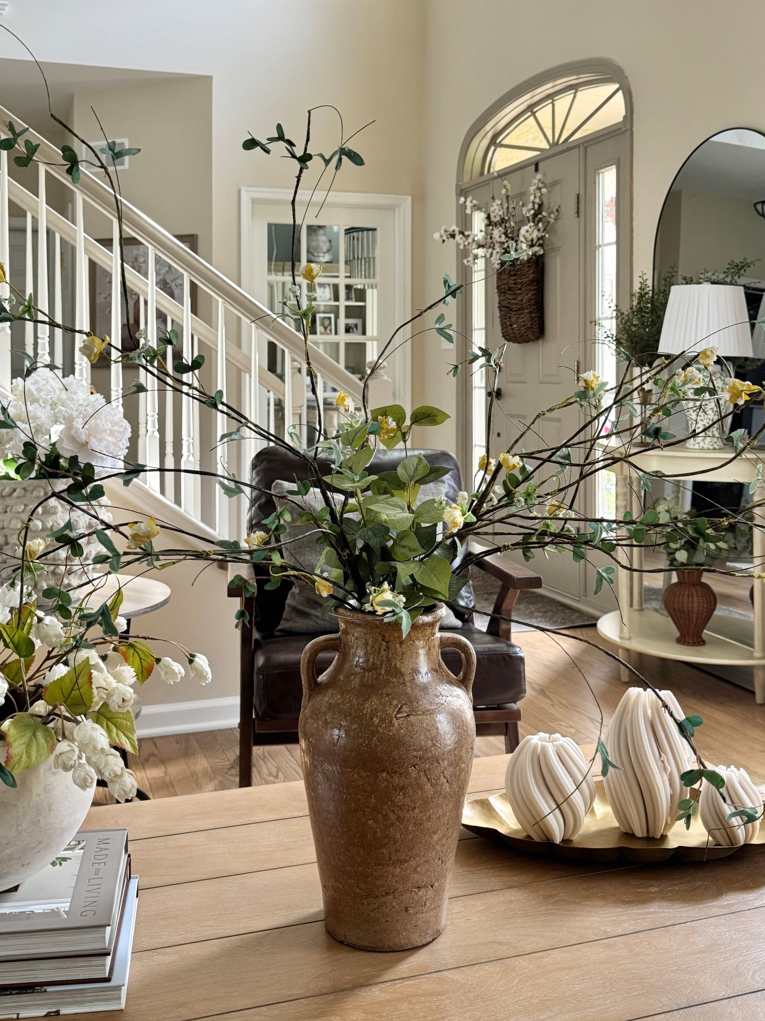 Beautiful swirled candles come in a few different colors and sizes. Accent chairs, tall rounded floor mirror, pretty floral lamp, scalloped brass tray, similar vases, stems, florals and door basket. 

#LTKHome