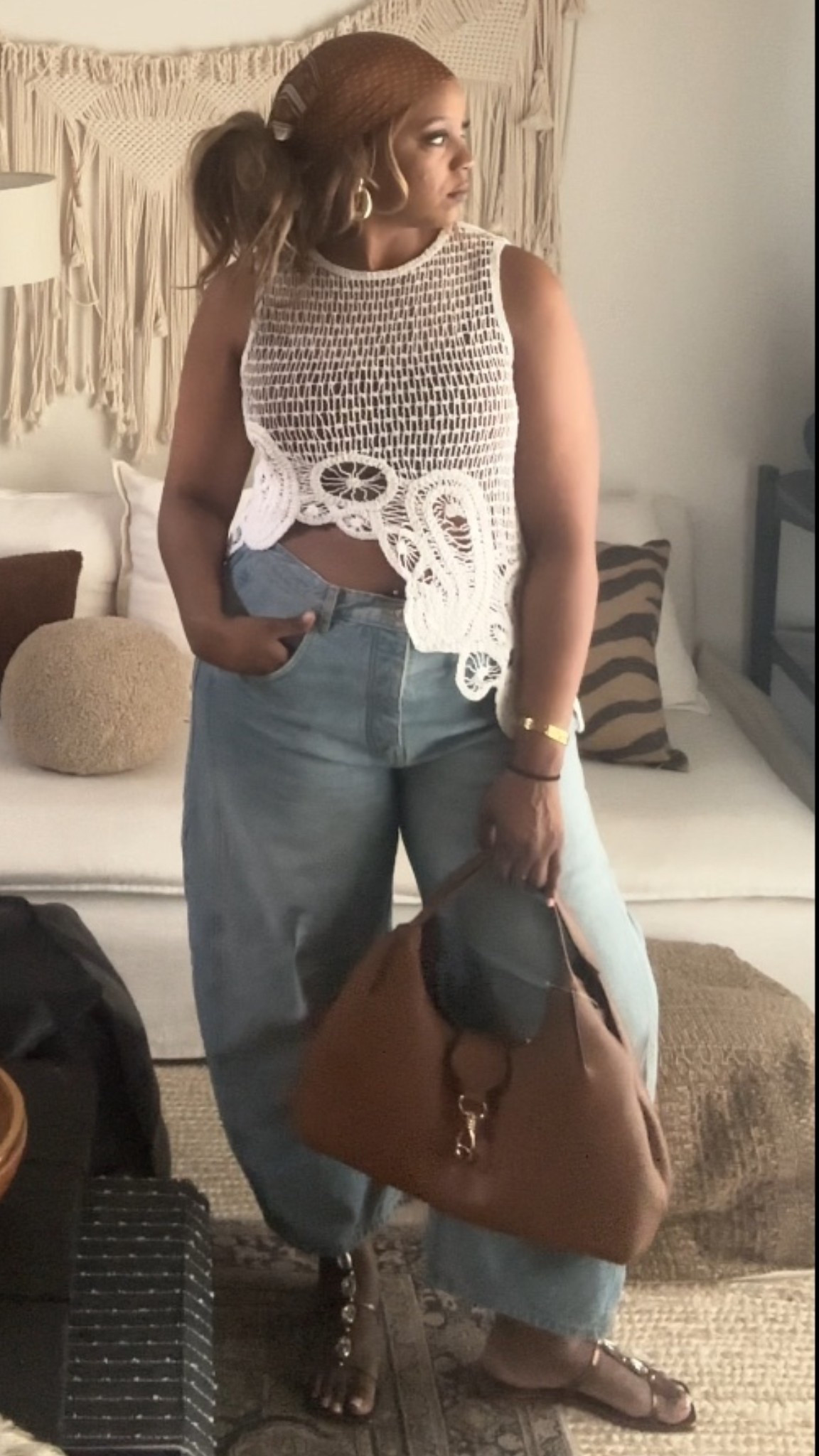 If you’re looking for a way to style the crochet trend without it feeling too "festival," this is how you do it. I’m pairing an intricate, asymmetric crochet knit with my favorite @freepeople relaxed-fit denim for a look that feels balanced, textured, and incredibly cool.
Why it works:
• The Crochet Top: This asymmetric hem and floral knit detail add so much visual interest. It’s light enough for spring but adds that "it-girl" edge to a basic outfit.
• The Barrel Jeans: To keep the look modern, I went with a medium-wash barrel leg. The extra volume at the leg contrasts perfectly with the structured knit of the top.
• The Accessories: I pulled in warm, earth tones with a silk headscarf and a slouchy leather hobo bag. It grounds the blue and white and gives it a vintage, luxe feel.
Fit Tip: The top is cropped and asymmetric, so I recommend pairing it with high-waisted denim to keep the proportions elongated.

#BohoChic #CrochetStyle #BarrelJeans #SpringOutfits #DenimDaily #NeutralVibes #LTKStyleTip

#LTKMidsize #LTKFestival #LTKootd