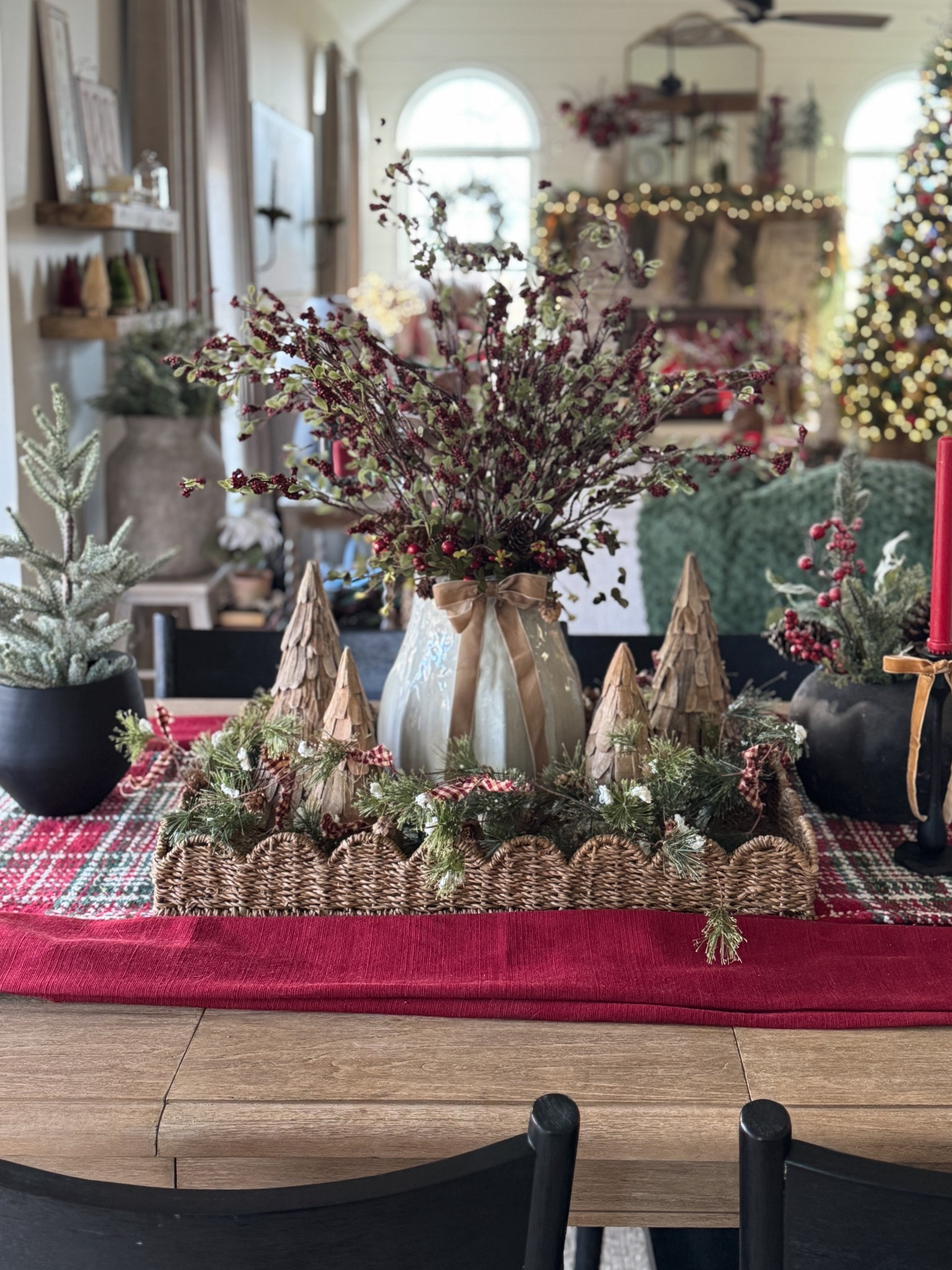 Christmas table and tray display. Scalloped wicker tray. Large white ceramic vase. Red berry stems. Similar trees to mine. Christmas table runner. Premade velvet bows. 

#LTKHoliday #LTKHome