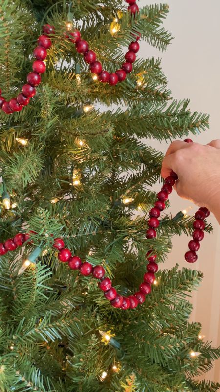 Christmas tree decorating with wood red bead garland

#LTKHoliday #LTKSeasonal #LTKhome