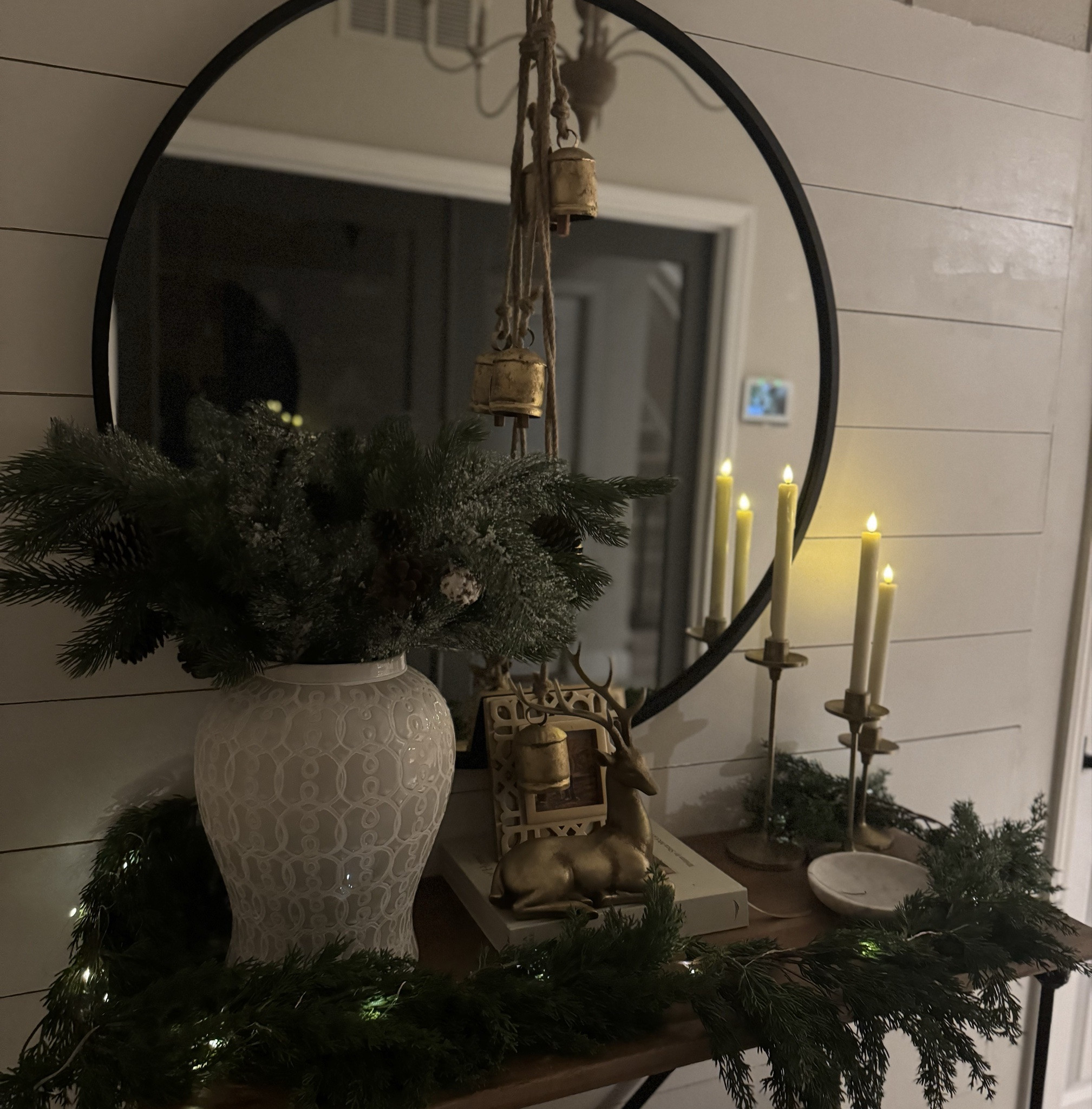 Layered Christmas entryway console décor with a designer look on a budget. 🎄✨
Using The Art of Home by Shea McGee, a 36” round black metal mirror, gold sitting deer décor, ivory flameless taper candles, and rustic cow bells on rope for the perfect classic holiday entryway.

#LTKHome #LTKHoliday #LTKCyberWeek